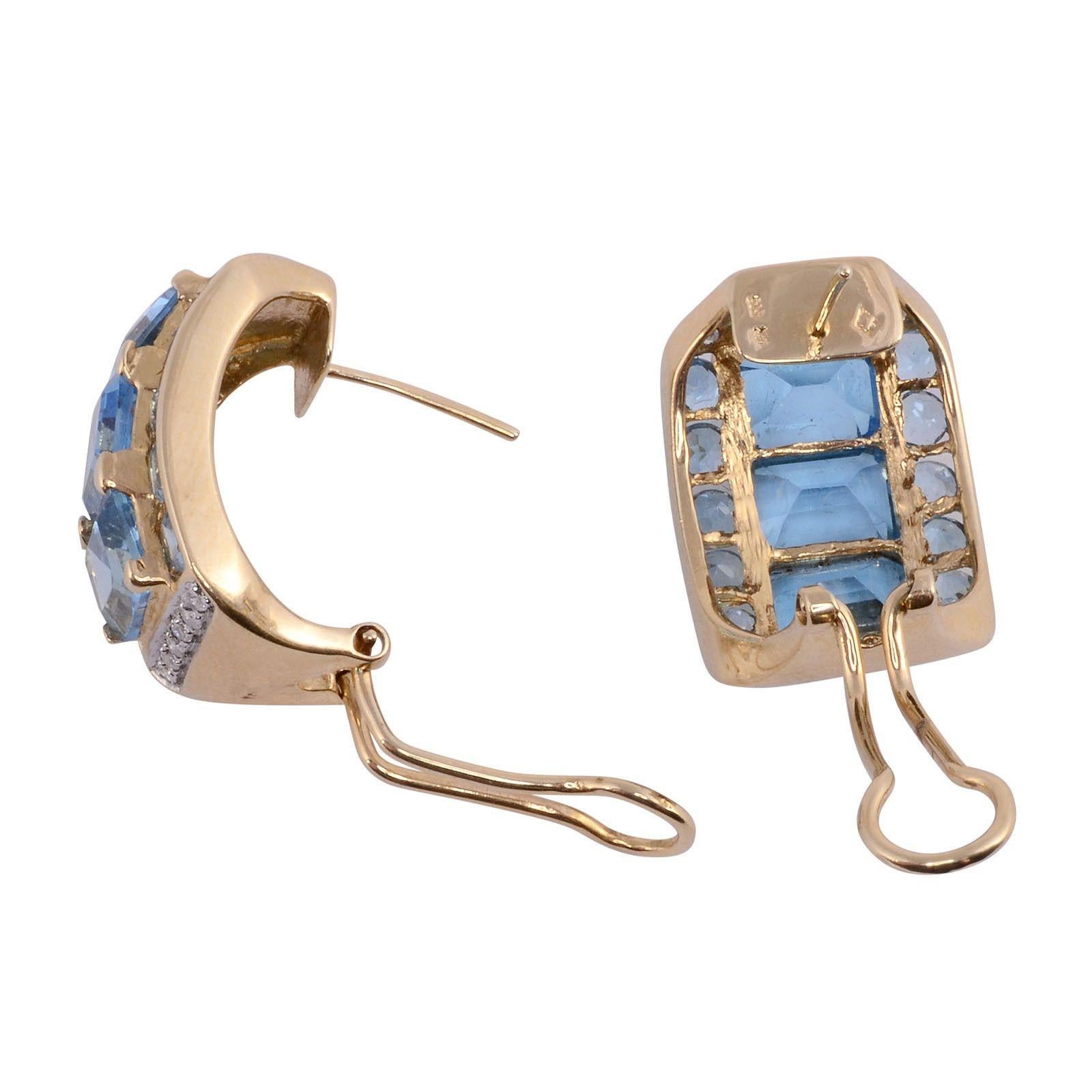 Estate emerald cut blue topaz earrings. These 14 karat yellow gold earrings feature six emerald cut blue topaz accented with 20 round blue topaz and 24 tiny round diamonds. [SJ 2280 P]
Dimensions
 
1″H x .62″W x .20″D