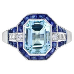 Anello in stile Art Deco con zaffiro blu taglio smeraldo e diamante in oro bianco 18 carati