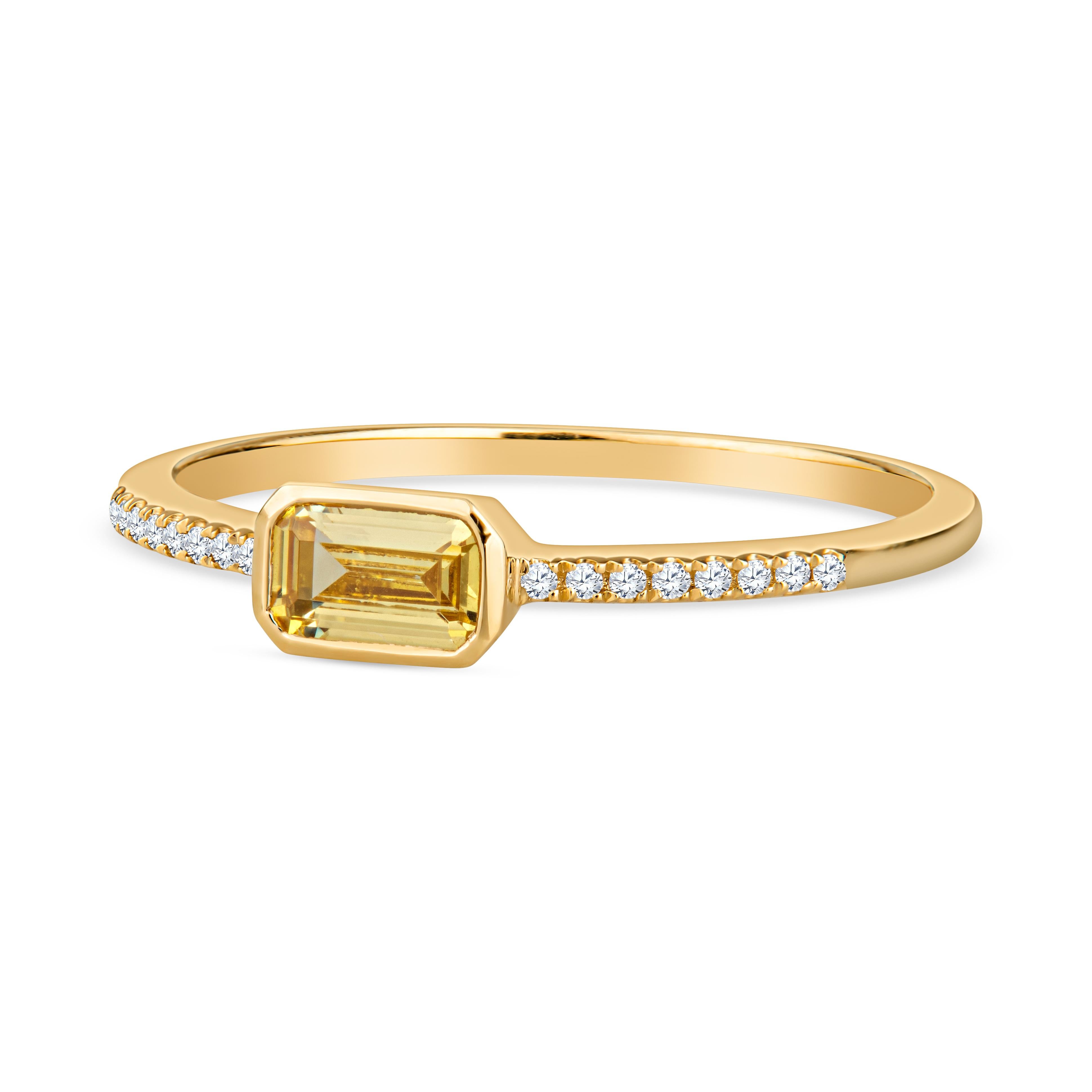 This dainty ring features a 0.46 carat emerald cut citrine set east-west accented by 0.04 carat total weight in round diamonds along the band set in 14 karat yellow gold. This ring is a size 6.5 but can resized upon request. Wear alone or stack with