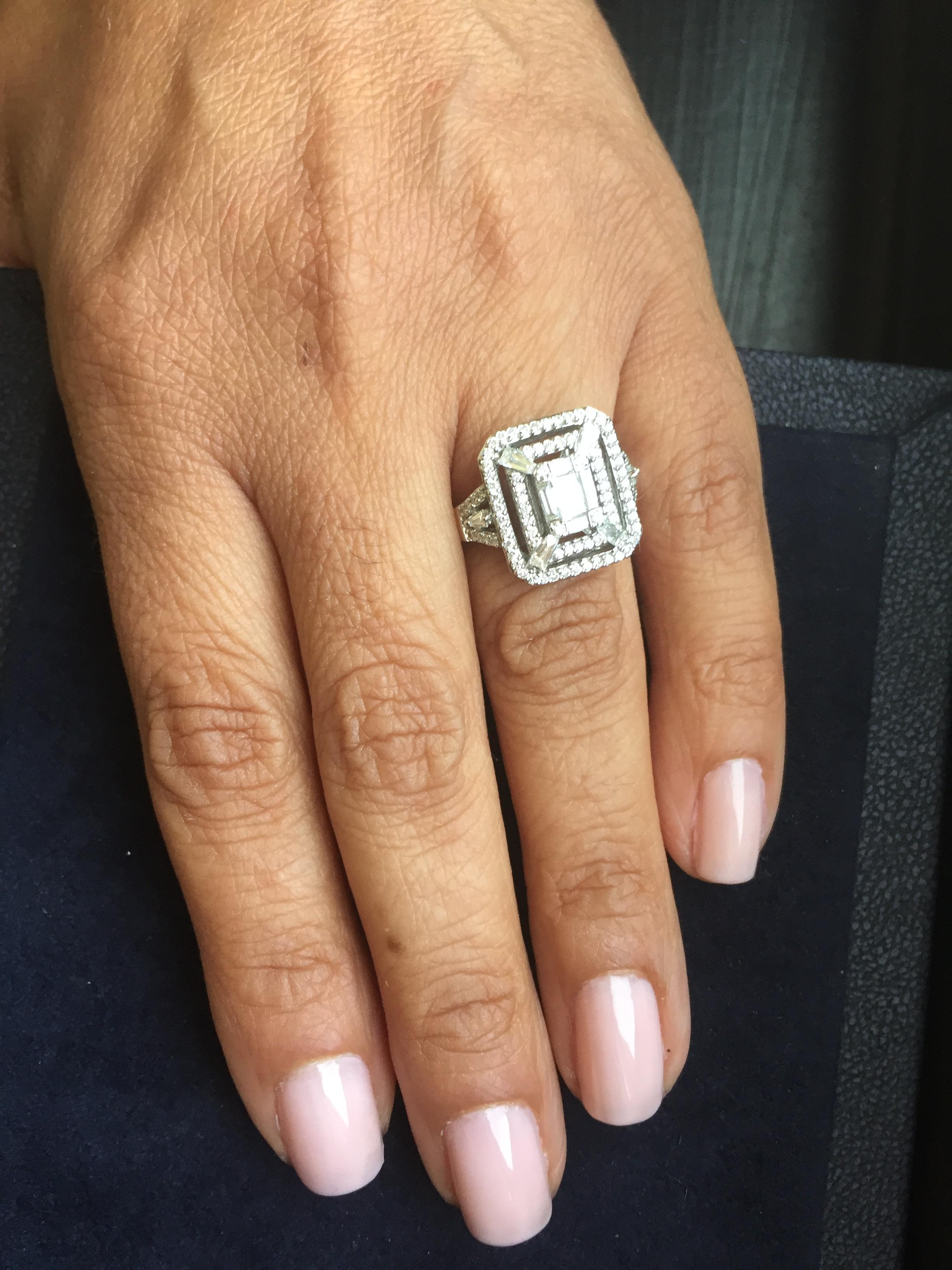 This cocktail ring is a true statement to any look. This ring has an emerald cut diamond in the middle and is surrounded by two rows of round diamonds. This ring is set in 18k White Gold, total Carat wt. is 1.20, color F, clarity VS.