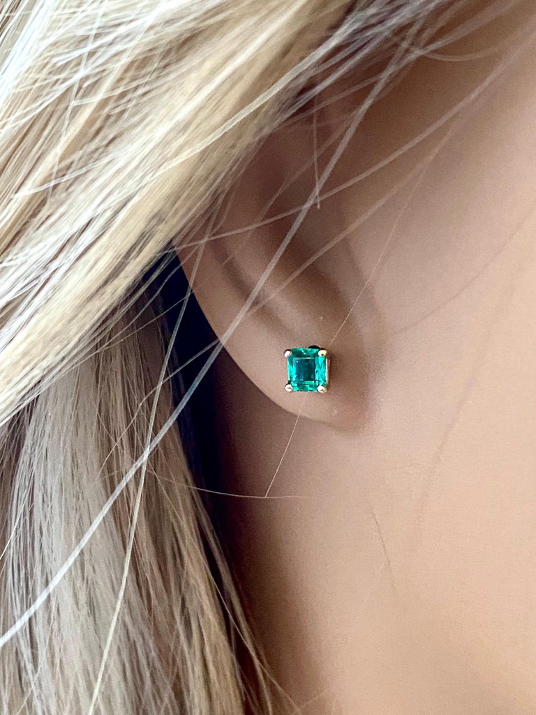 14 karats yellow gold 0.18 inch width Colombia emerald stud earrings 
Emerald-Cut Emeralds weighing 0.75 carats
New Earrings
Handmade in the USA
The 14 karat gold earrings are hanging off a post with push-backs
The emerald color is deep summer grass