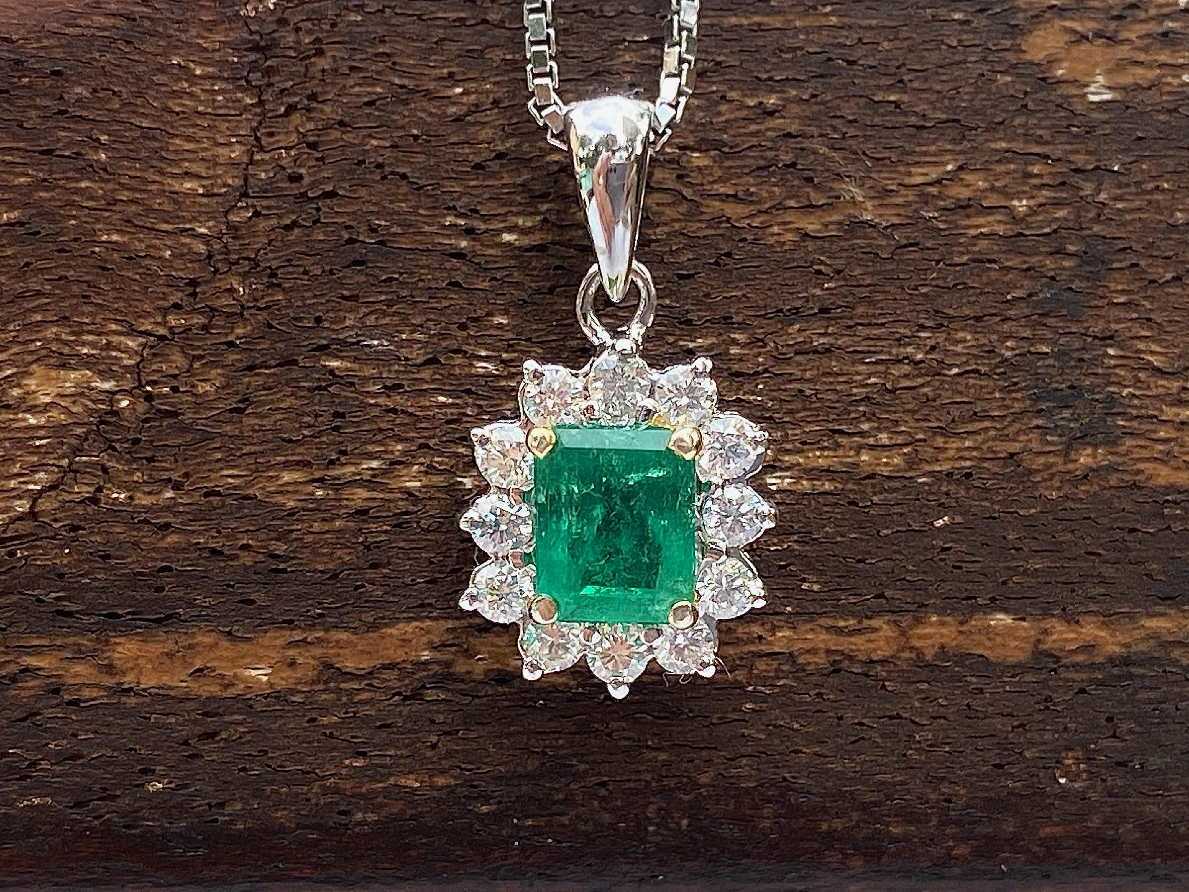 Centering a 0.46 Carat Emerald-Cut Colombian Emerald, accented by 12 Round-Brilliant Cut Diamonds totaling 0.22 Carats, and set in 18K White Gold.
Natural Emerald pendant of Colombian origin. Emerald step cut center stone for optimal brilliance and