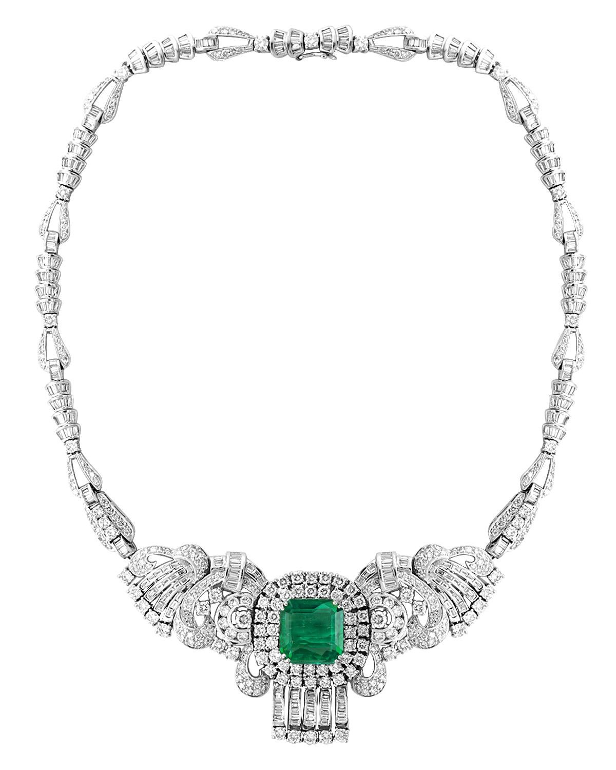 Platinum Colombian  Emerald and diamond  necklace, consisting of one large  approximately 16 Carat Emerald cut Colombian Emerald  with  round brilliant cut diamonds surrounding it .
The Necklace is made with  Buggetts and round diamonds . All prong