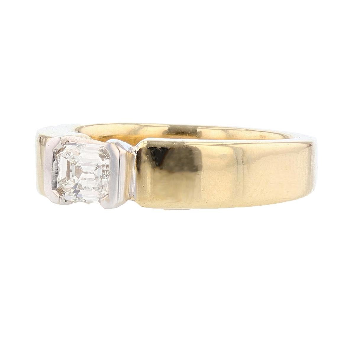 This ring is made with 14 karat yellow and white gold and features a bezel set 0.54ct  emerald cut diamond  with a color grade (I) and clarity grade (SI2). 