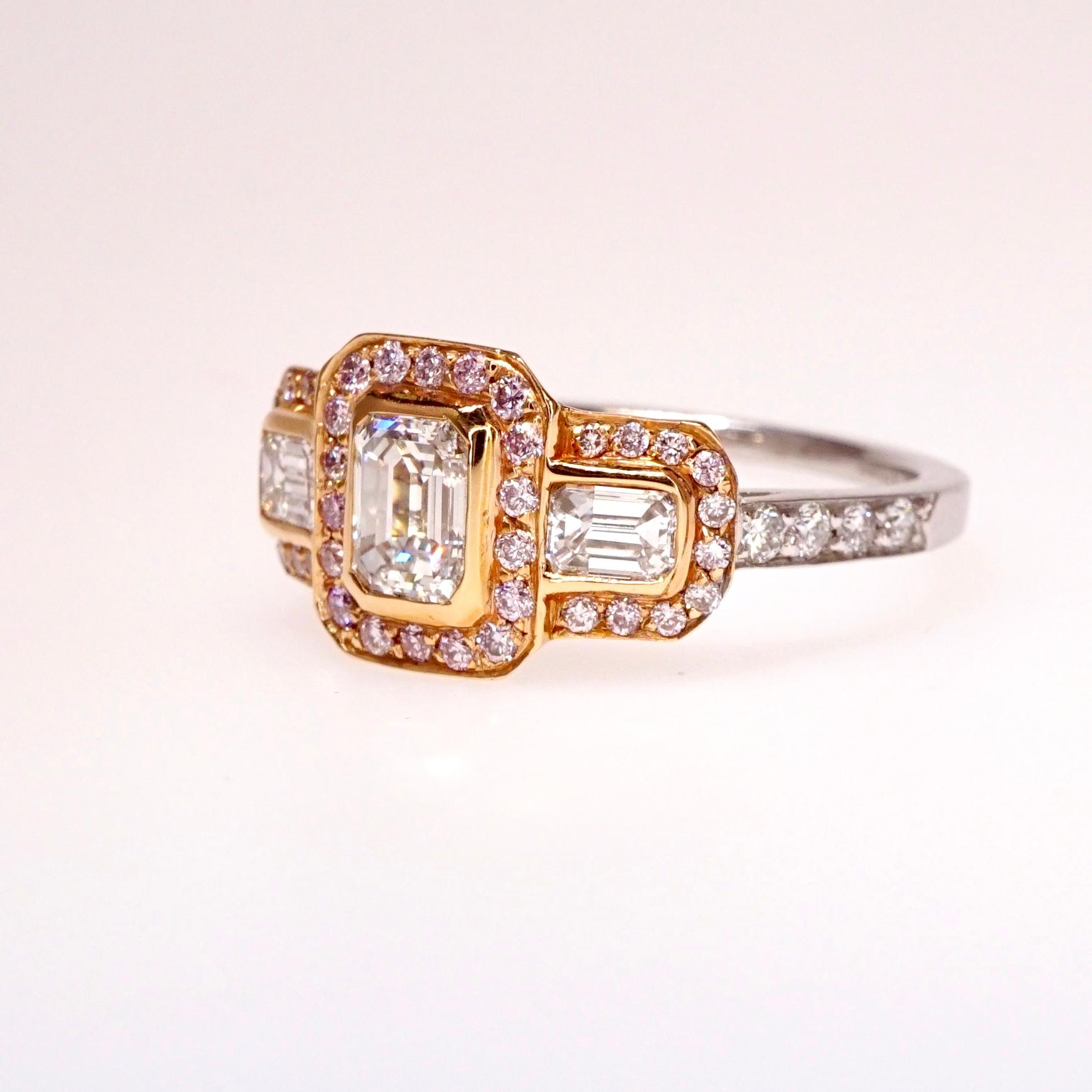 Diamond ring with Emerald cut natural diamond center stone and 2 Emerald cut side stones: 1.40tcw F VS1. Side stones: .55ct Natural Fancy Light Pink Diamonds VS2-SI1 and .25ct Natural Brilliant Round Diamonds  F-G VS2. Total carat weight: 2.20ct.