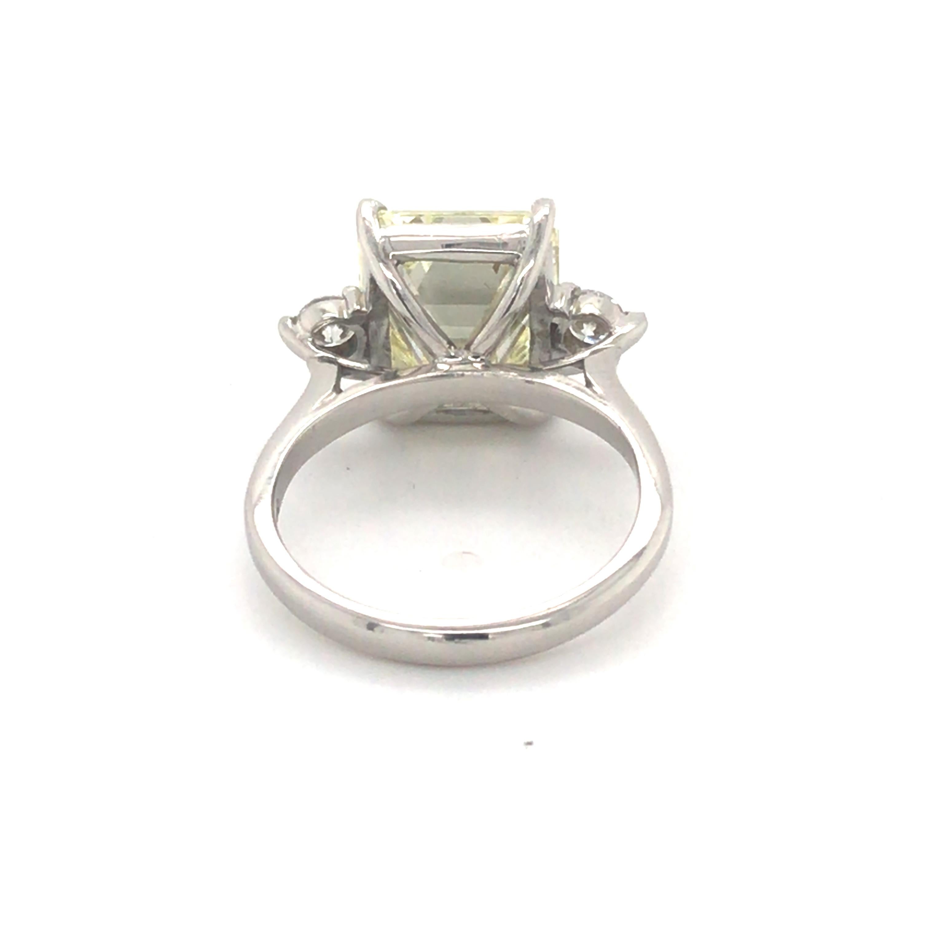 Auscert certified emerald cut diamond 6.375ct P VS1, measuring 11.71mm x 10.22m x 6.06mm set in 18ct white gold with 2 brilliant cut diamonds either side with total weight for the 2 = 0.28ct GHSI.
A lovely quality stone enhanced in a simple white