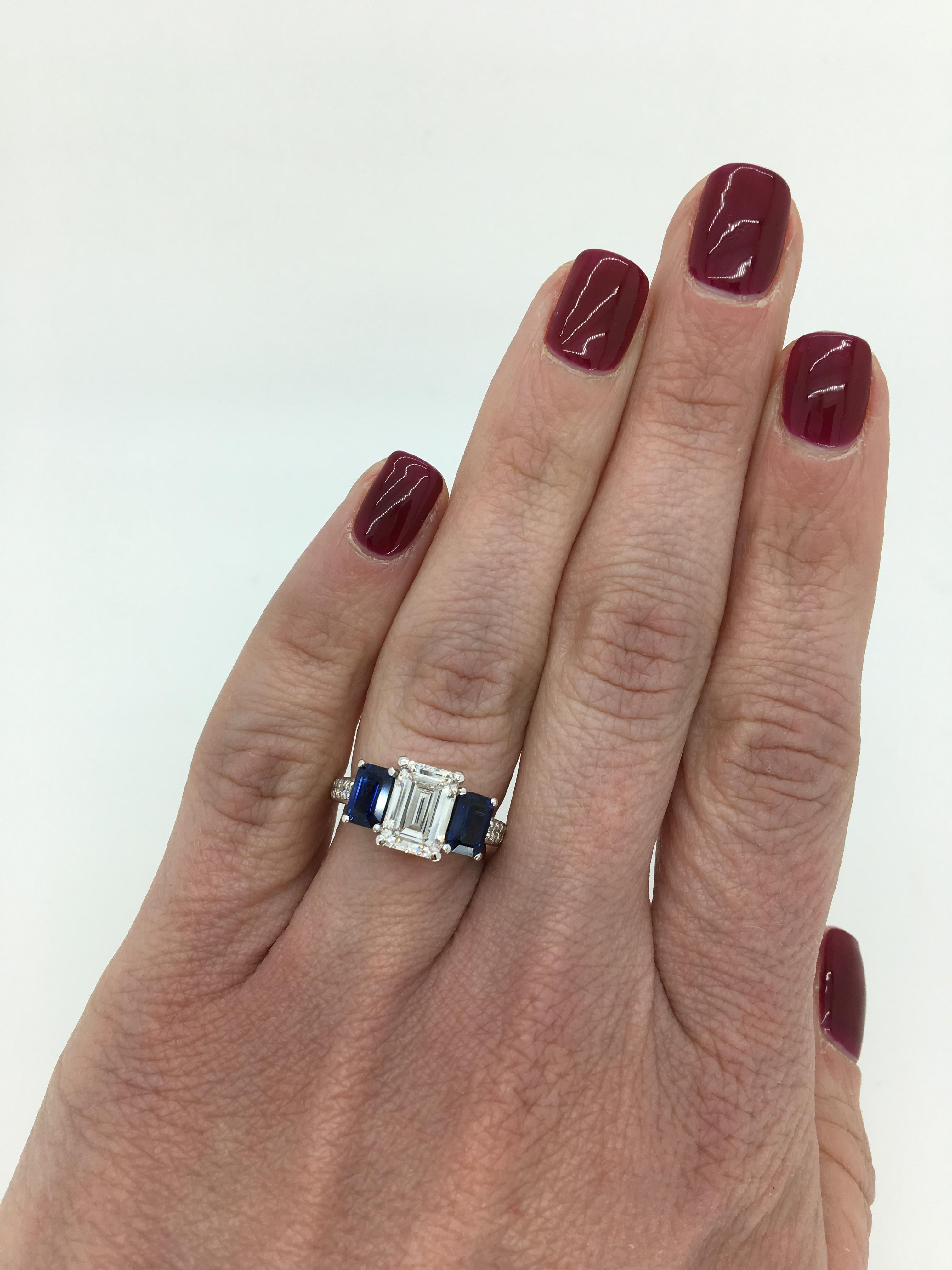 Classic three stone Emerald Cut engagement ring with accenting Blue Sapphires crafted in 14K white gold.

Gemstone: Diamond and Sapphire
Gemstone Size: Two Approximately 3.75x6mm Rectangular Cut Blue Sapphires
Center Diamond Carat Weight: