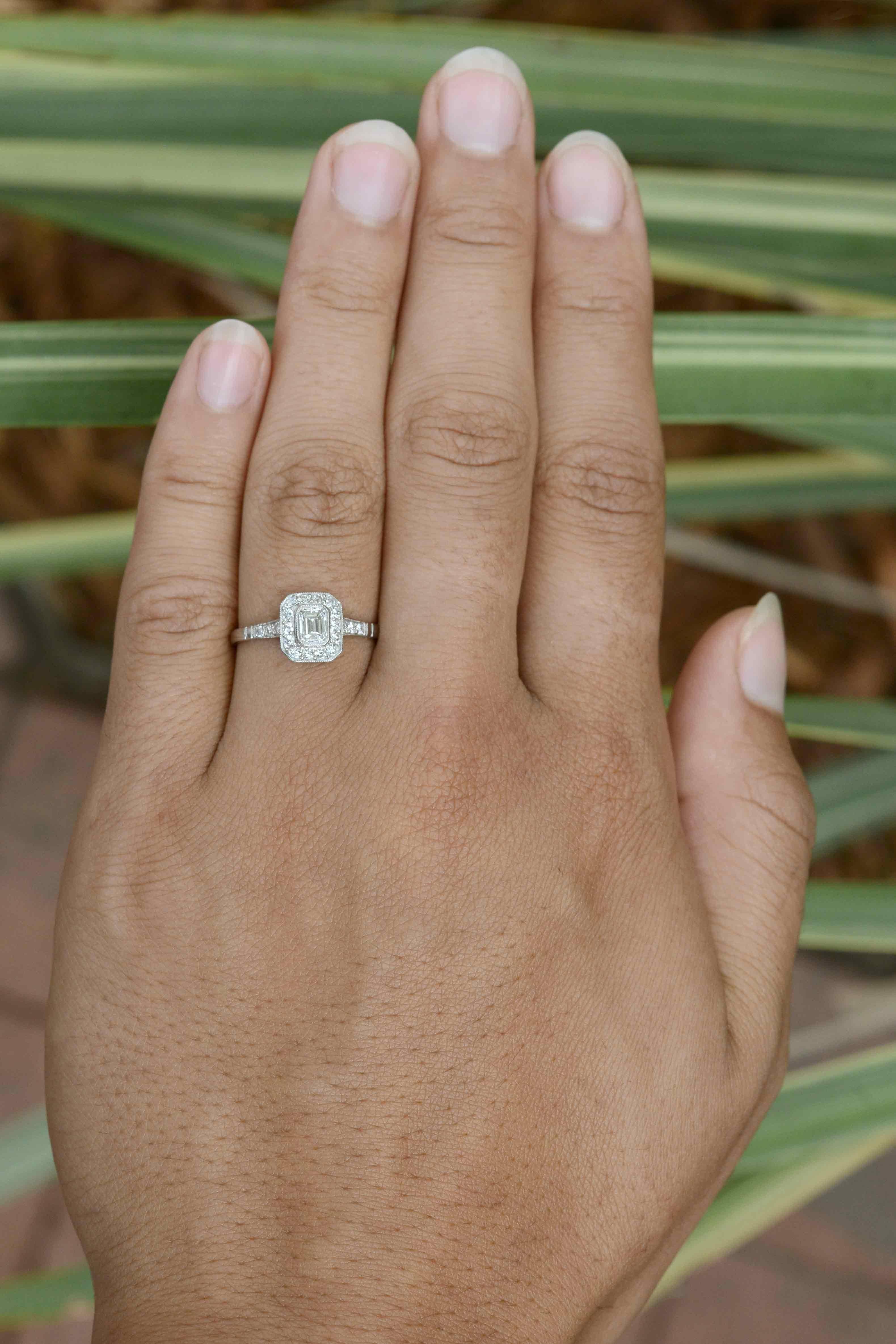 The elegant simplicity of an emerald cut diamond engagement ring is always fashionable. Faithfully rendered in the Art Deco style, the bezel setting boasts a milgrain halo of shimmering old European cut diamonds. 

Why you'll love it: The central