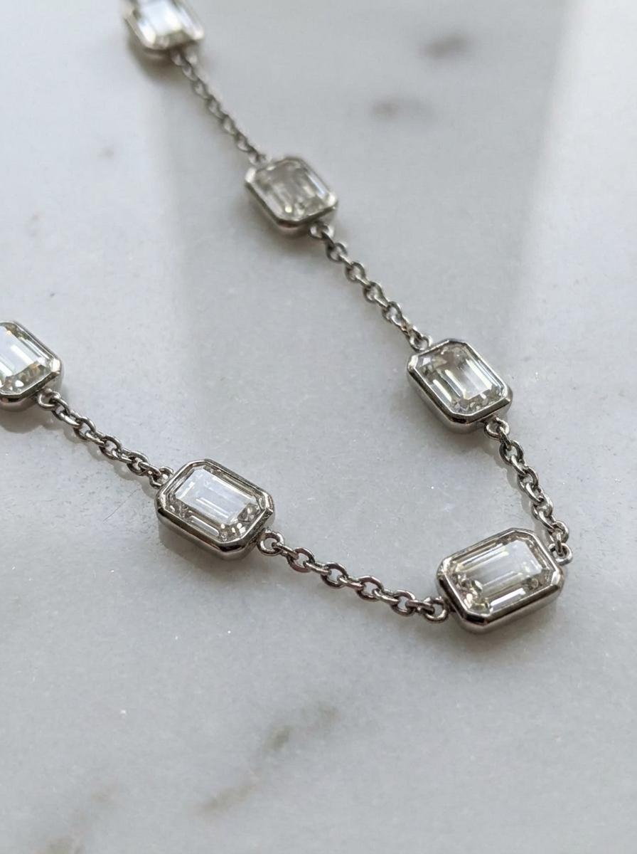 This exquisite emerald-cut diamond by-the-yard necklace showcases timeless elegance and refined craftsmanship, featuring a total of 15.00 carats of natural diamonds set in luminous 18K white gold. Each diamond is individually bezel-set along the