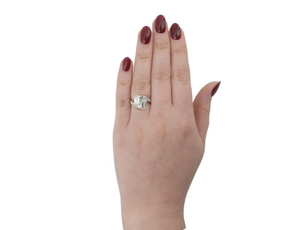 Emerald Cut Emerald-cut diamond cross over ring, American, circa 1950. For Sale