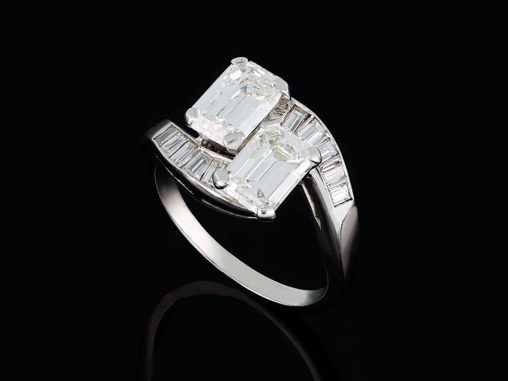 Women's or Men's Emerald-cut diamond cross over ring, American, circa 1950. For Sale