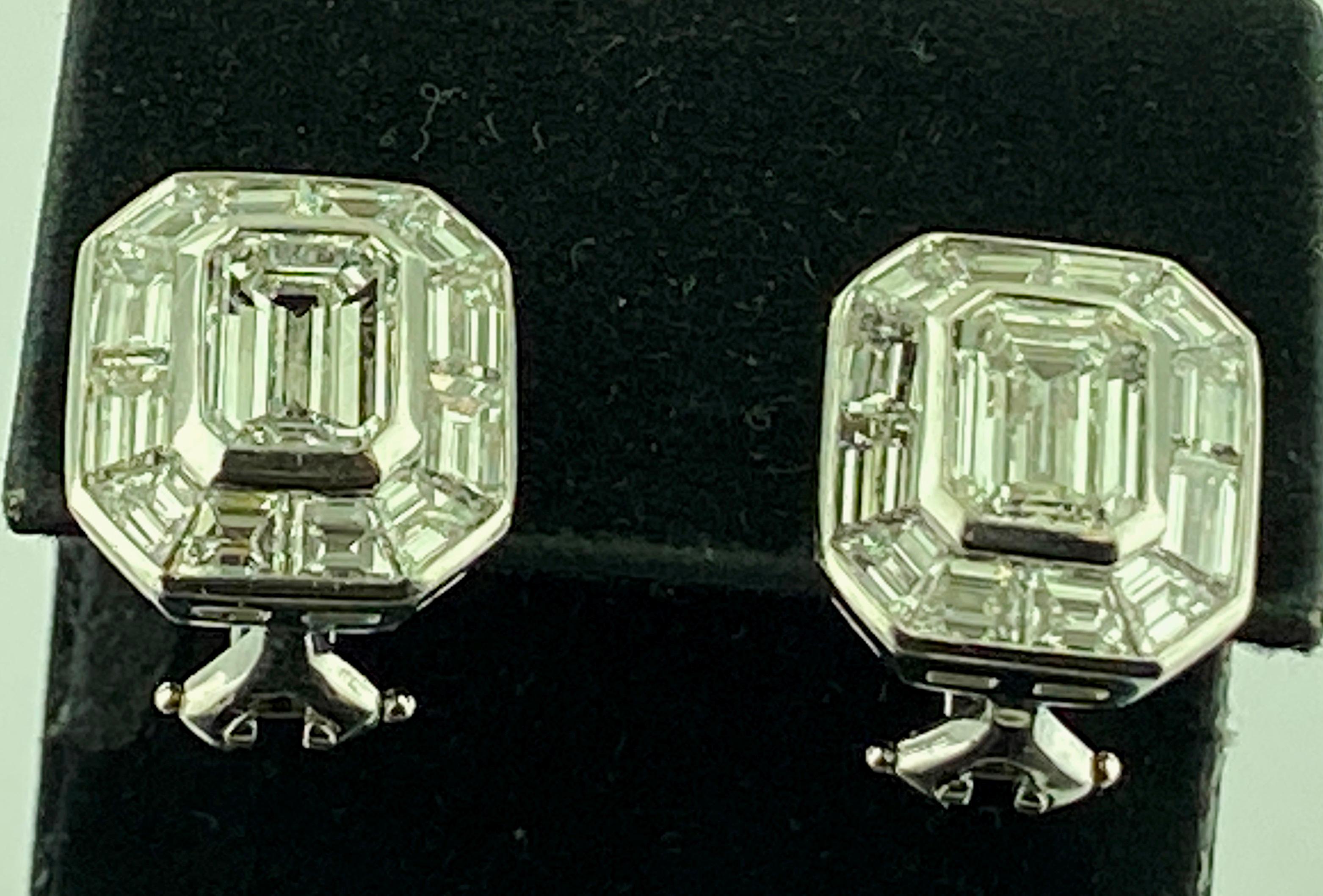 Set in Platinum, weighing 13.4 grams in French Clips are two center Emerald Cut diamonds with a total diamond weight of 2.40 carats.  Color: G-H, clarity: VS-1.  Surrounding the center emerald Cut diamonds are 24 Baguette Cut diamonds with a total