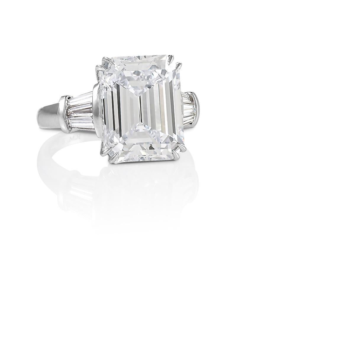 Any emerald-cut lover will fall for this nearly eight-carat diamond classic engagement ring with its ideal platinum proportions, mirrored depths, and broad flashes of white light. The emerald-cut diamond was the result of increasing precision and