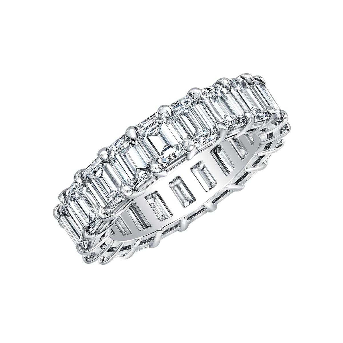 Eternity band ring, showcasing fine colorless emerald-cut diamonds mounted in a shared-prong platinum setting.

Twenty diamonds weighing 6.35 total carats (E-F color, VVS1-VVS2 clarity)
Size 6