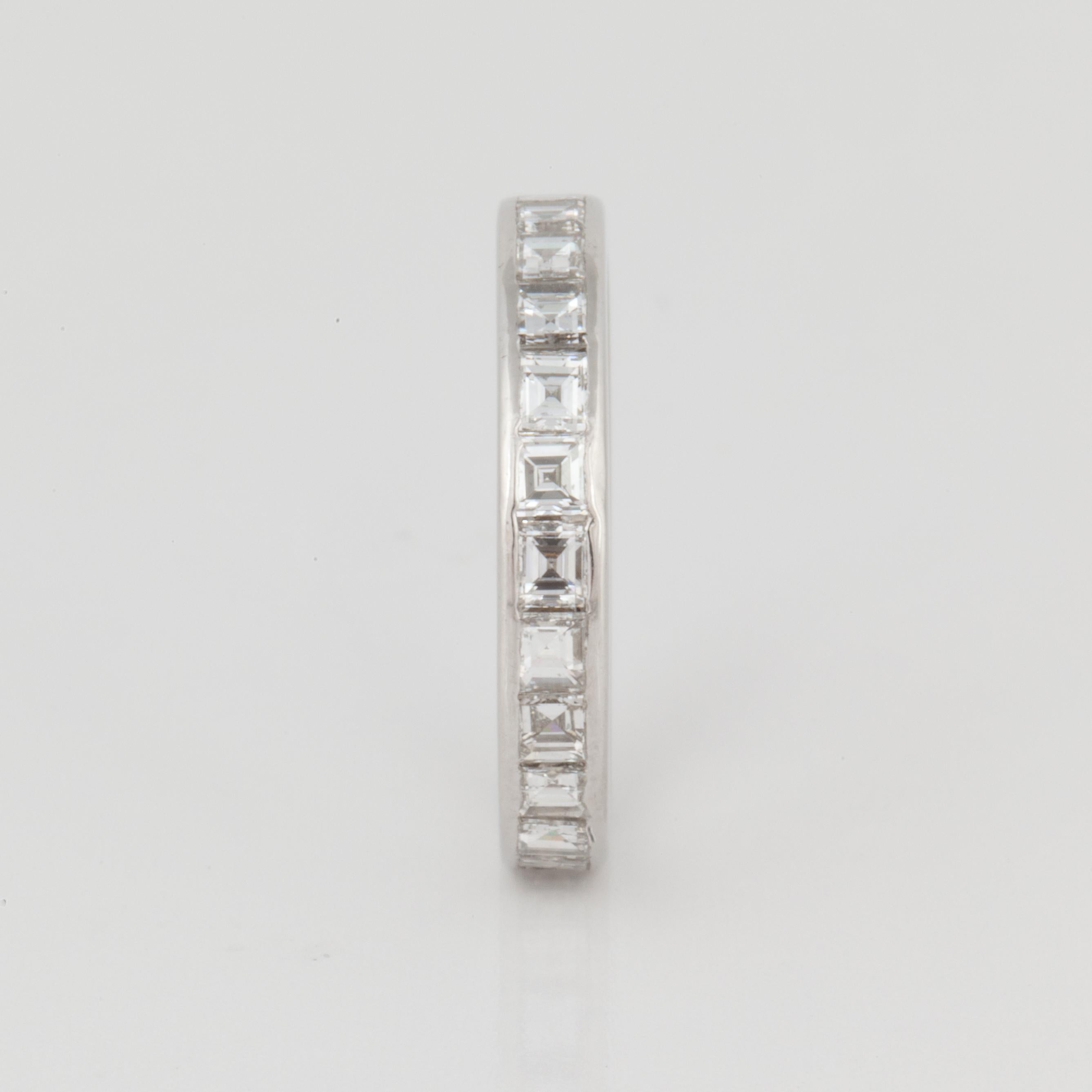 Diamond eternity band in platinum featuring emerald-cut diamonds.  There are twenty-four (24) diamonds totaling 2.80 carats; G-H color and VVS2-VS1 clarity.  The ring is a size 6 3/4 and measures 1/8 inch wide.