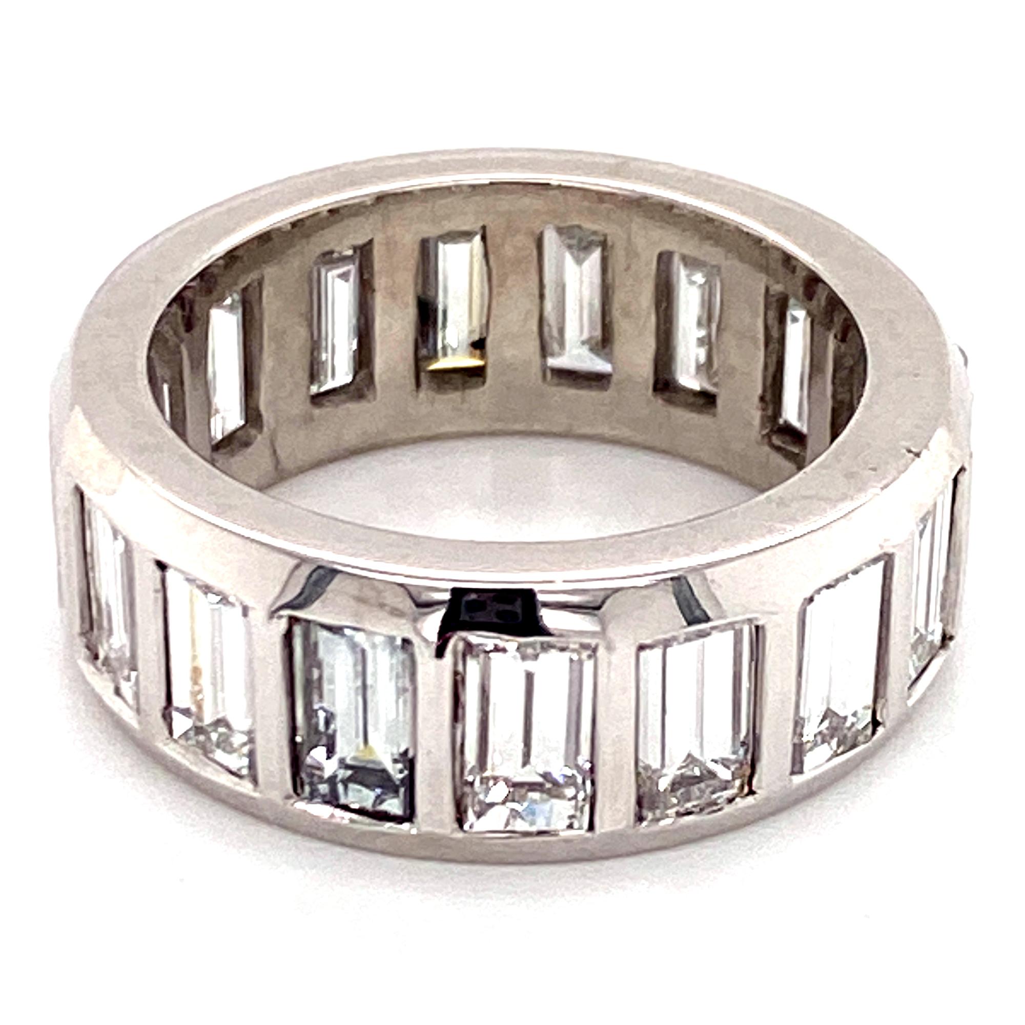 Gorgeous emerald cut diamond eternity band hand crafted in platinum. The band features 17 emerald cut diamonds weighing approximately 7.00 carat total weight. The diamonds are graded H-I color and VS clarity. The ring is size 6.5, and measures