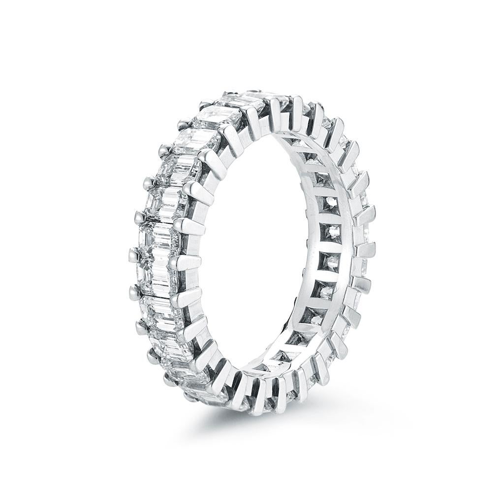 Emerald cut prong set diamond eternity band. This stunning wedding band is set with 27 emerald cut diamonds totaling 3.25 Carats. We guarantee that you will receive a ring with 3.25 carats in total or more depending on your finger size. Kindly
