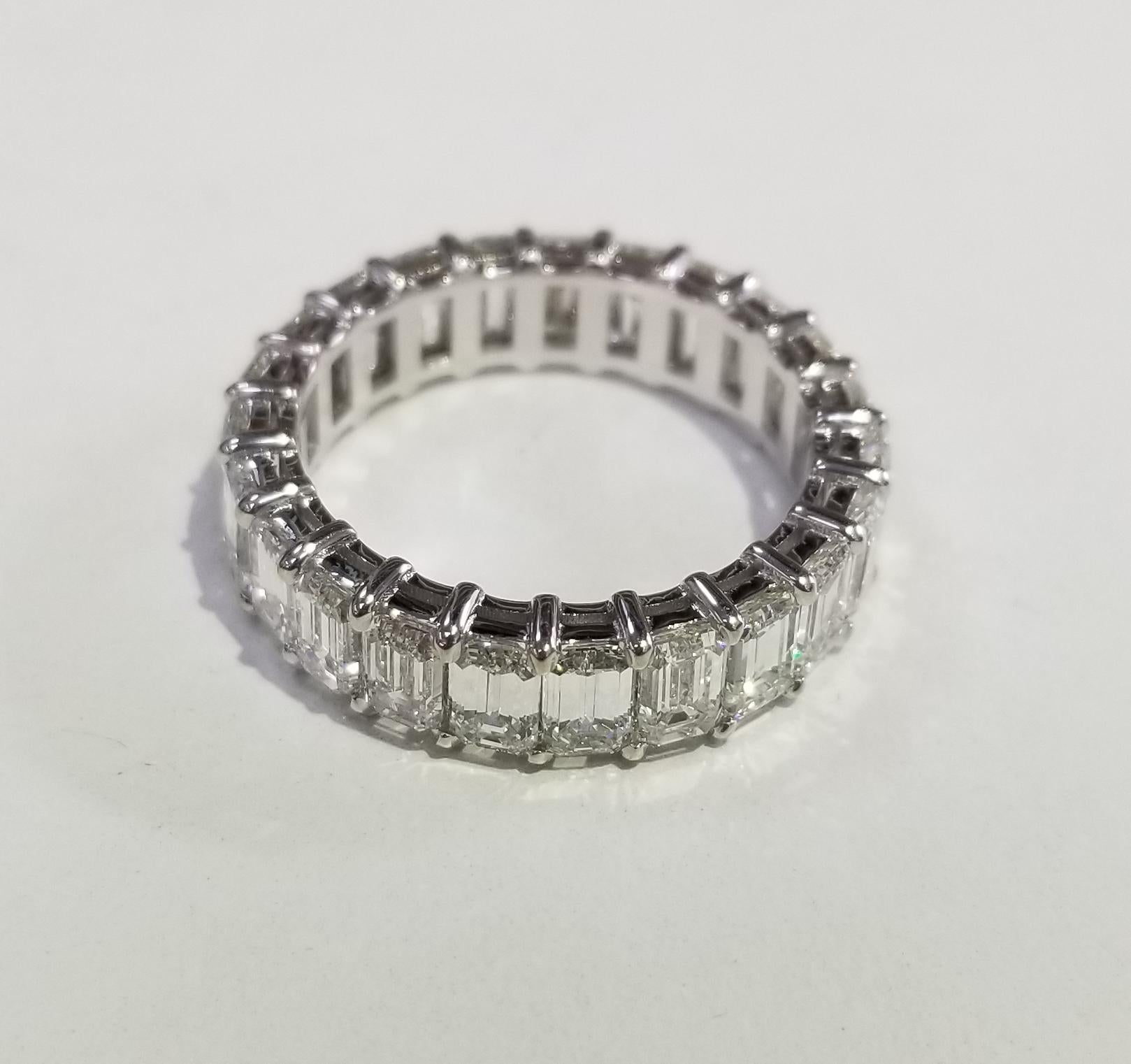 A breathtakingly beautiful diamond wedding band featuring 23 emerald cut diamonds set in 14k white gold weighing 7.25carats. These spectacular diamonds are G in color, VS1-2  clarity. This seamless eternity band is expertly crafted surely will catch