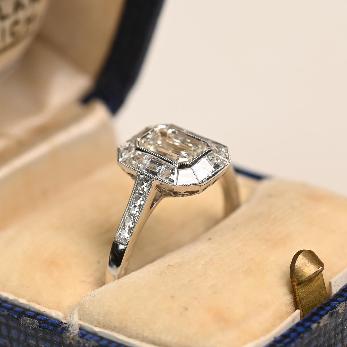 Une bague de fiançailles géométrique saisissante mettant en valeur un diamant taille émeraude certifié par le GIA pesant environ 2,00 carats, de couleur I et de pureté VVS1. La pierre centrale affiche une brillance et une précision exceptionnelles,