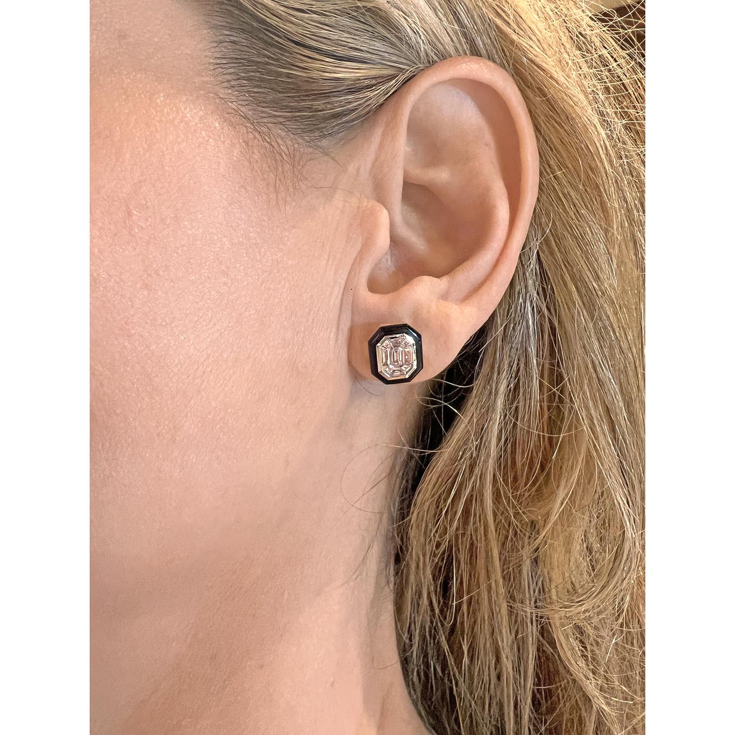 Octagonal-shaped diamond mosaic stud earrings, centering an emerald-cut diamond surrounded by calibre-cut diamonds bezel-set in 18k white gold and framed in carved black agate.  Eighteen diamonds weighing 2.28 total carats (two largest diamonds at