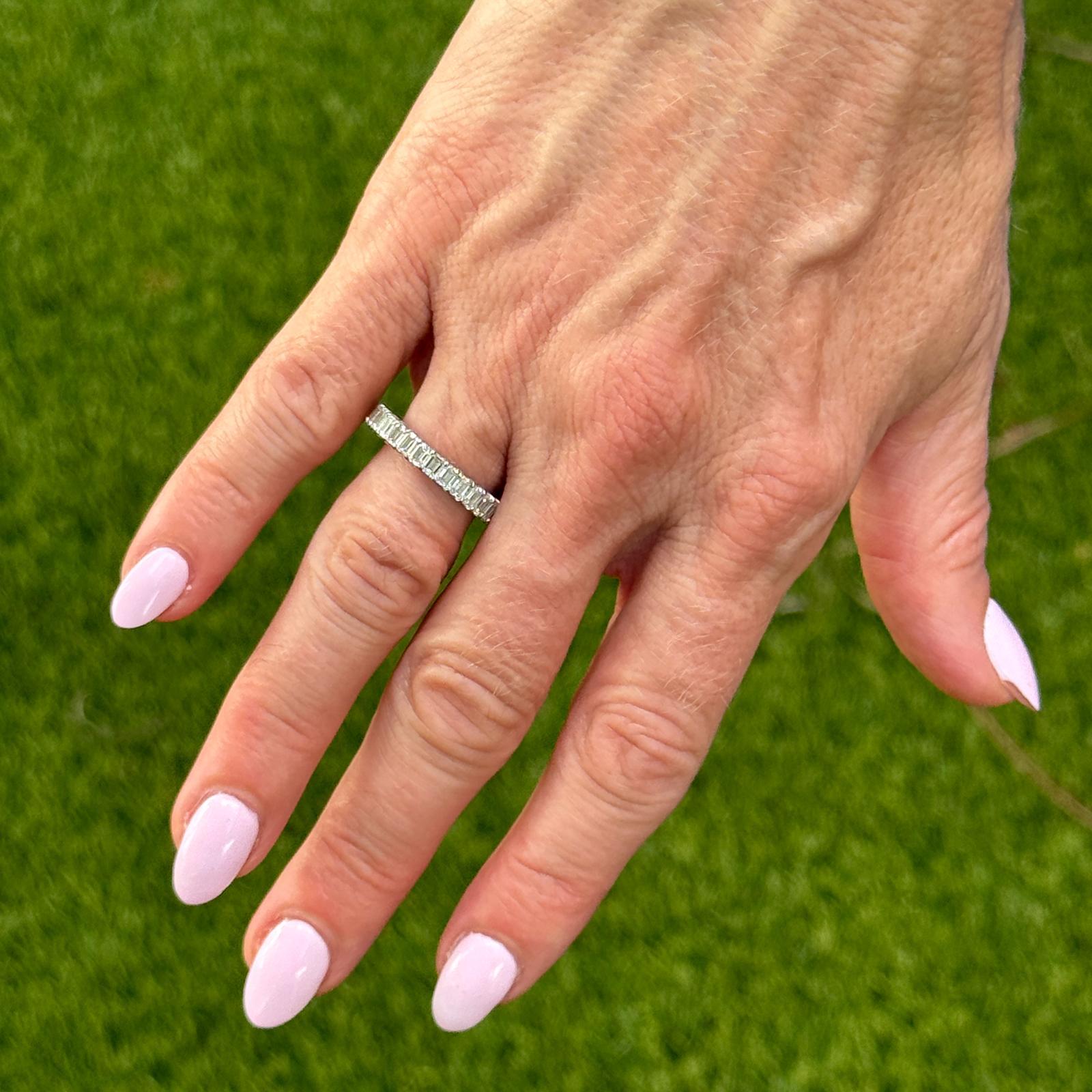 Elegant and timeless, this Platinum Diamond Eternity Band showcases 29 emerald-cut diamonds with a total weight of approximately 2.30 carats. The diamonds are graded G-H in color and VS2-SI1 in clarity, offering a beautiful balance of brilliance and