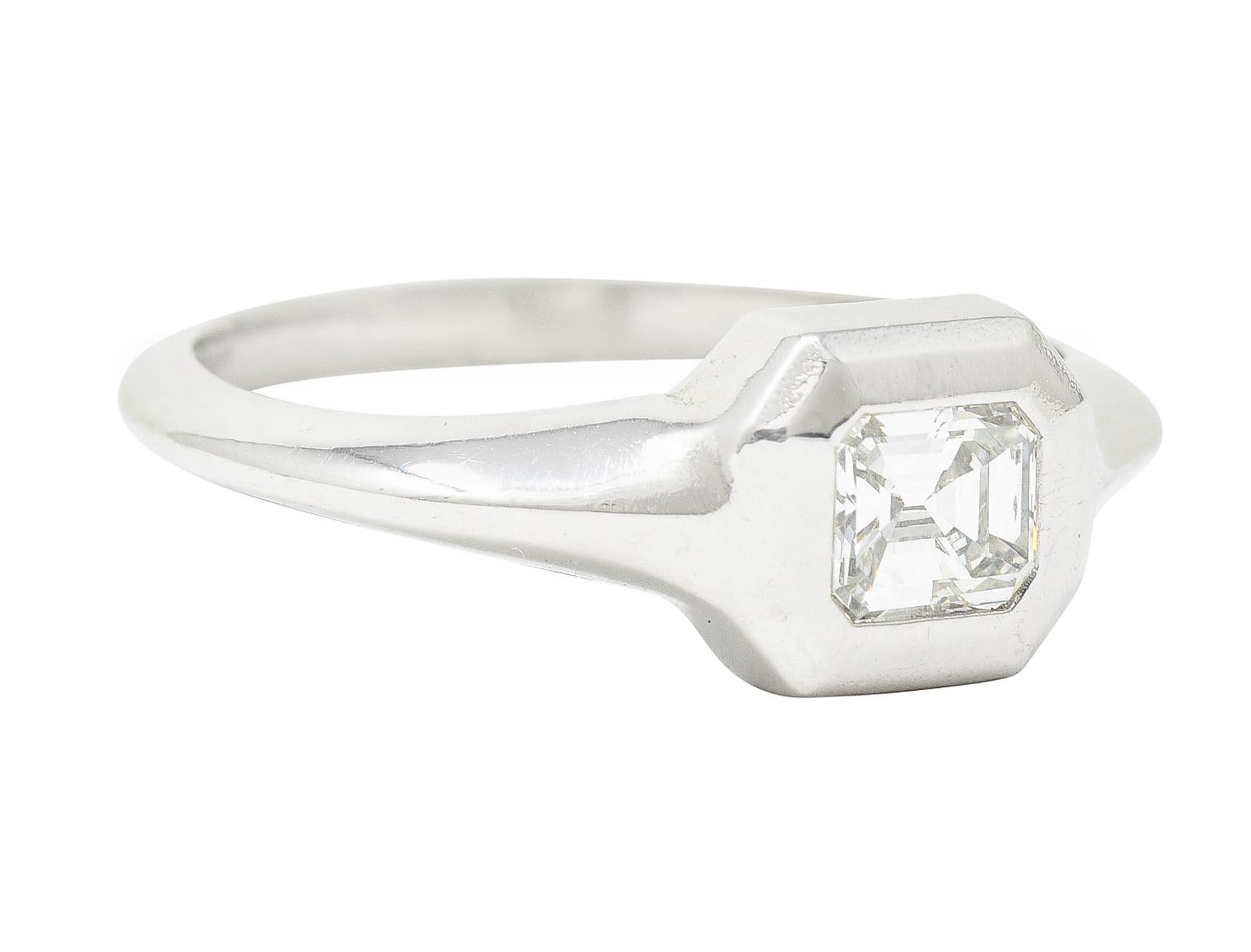 Centering an emerald cut diamond weighing approximately 0.50 carat total
G color with VS2 clarity
Flush set in a faceted octagonal form head
With a knife edge shank
Tested as platinum
Circa: 21st century
Ring size: 7 and sizable
Measures: North to