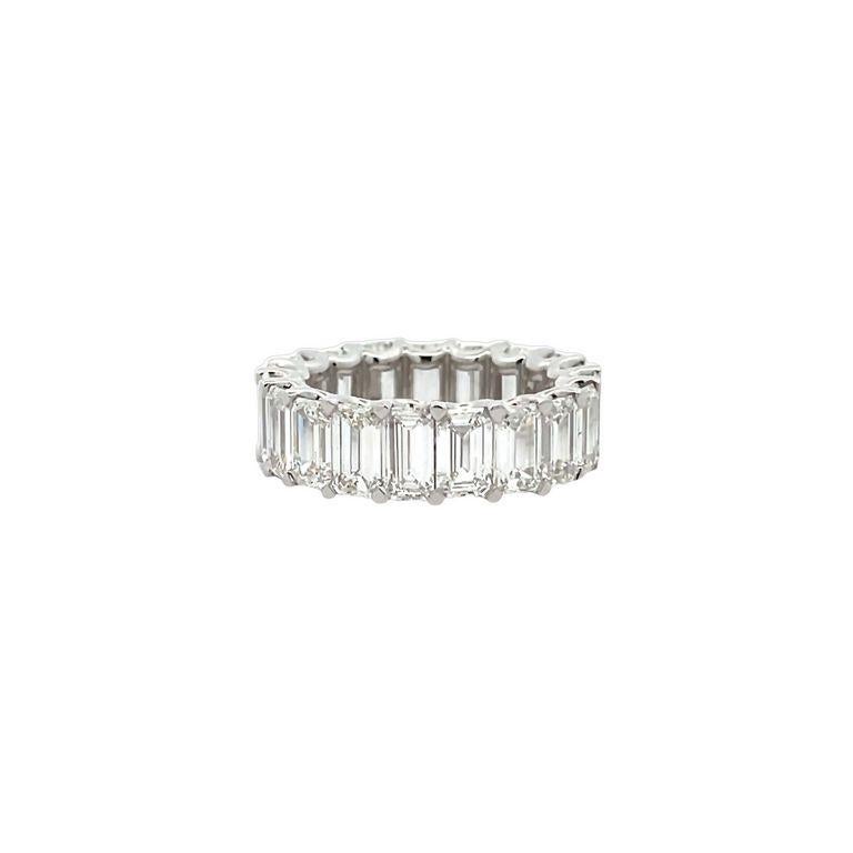 This exquisite ring embodies the notion of eternal love through its intricate details. The emerald-cut diamonds in F color with VS1 clarity, weighing a total of 9.94 carats, are arranged in a circular pattern around the band, creating an