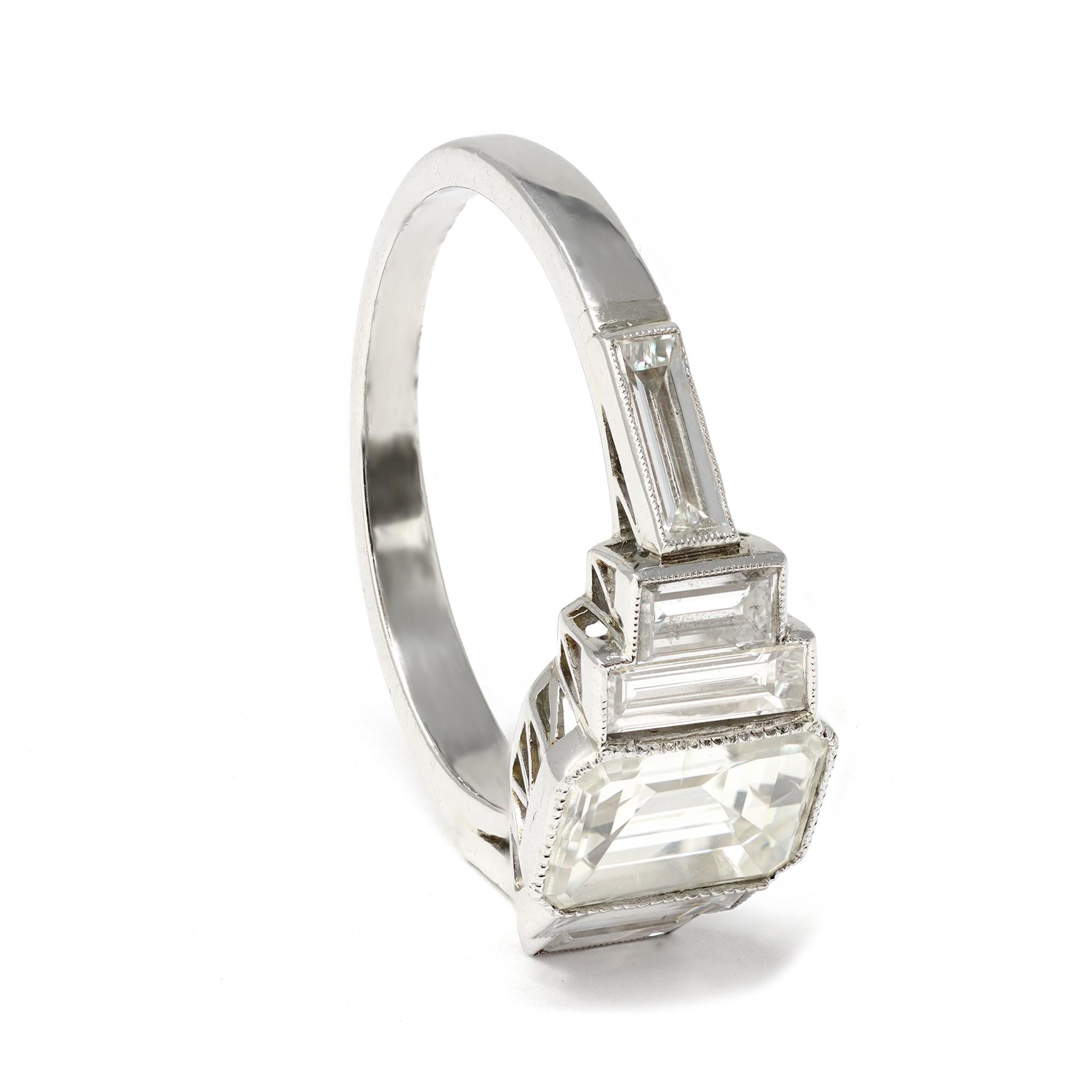 An elegant and classic engagement ring featuring an emerald-cut center diamond weighing 2.02 carats, graded J color and SI1 clarity accompanied by EGL report No US 62649002D. The center diamond is flanked with 6 side baguette diamonds of H color and