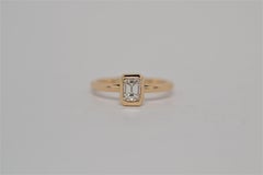 Emerald Cut Diamond Solitaire Ring set in 14k Yellow Gold Bezel, 0.61 Carats