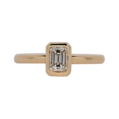 Emerald Cut Diamond Solitaire Ring set in 14k Yellow Gold Bezel, 0.61 Carats