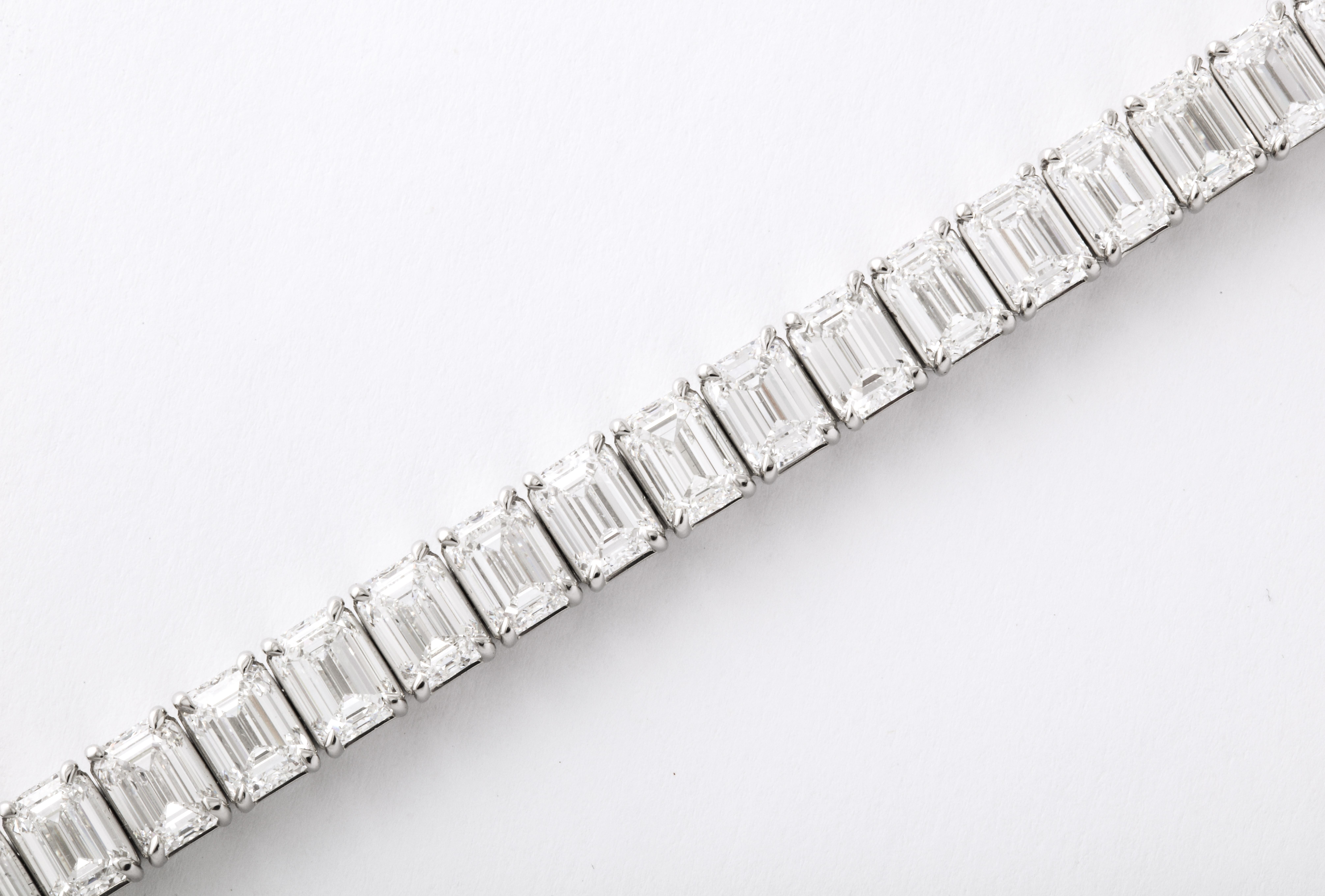 
A SENSATIONAL bracelet!

A beautiful layout of GIA Certified diamonds, all with ideal measurements - 37 total Emerald cut diamonds weighing 26.81 carats!

GIA Certified DEF color VS+ clarity diamonds set in a custom platinum mounting. 

The