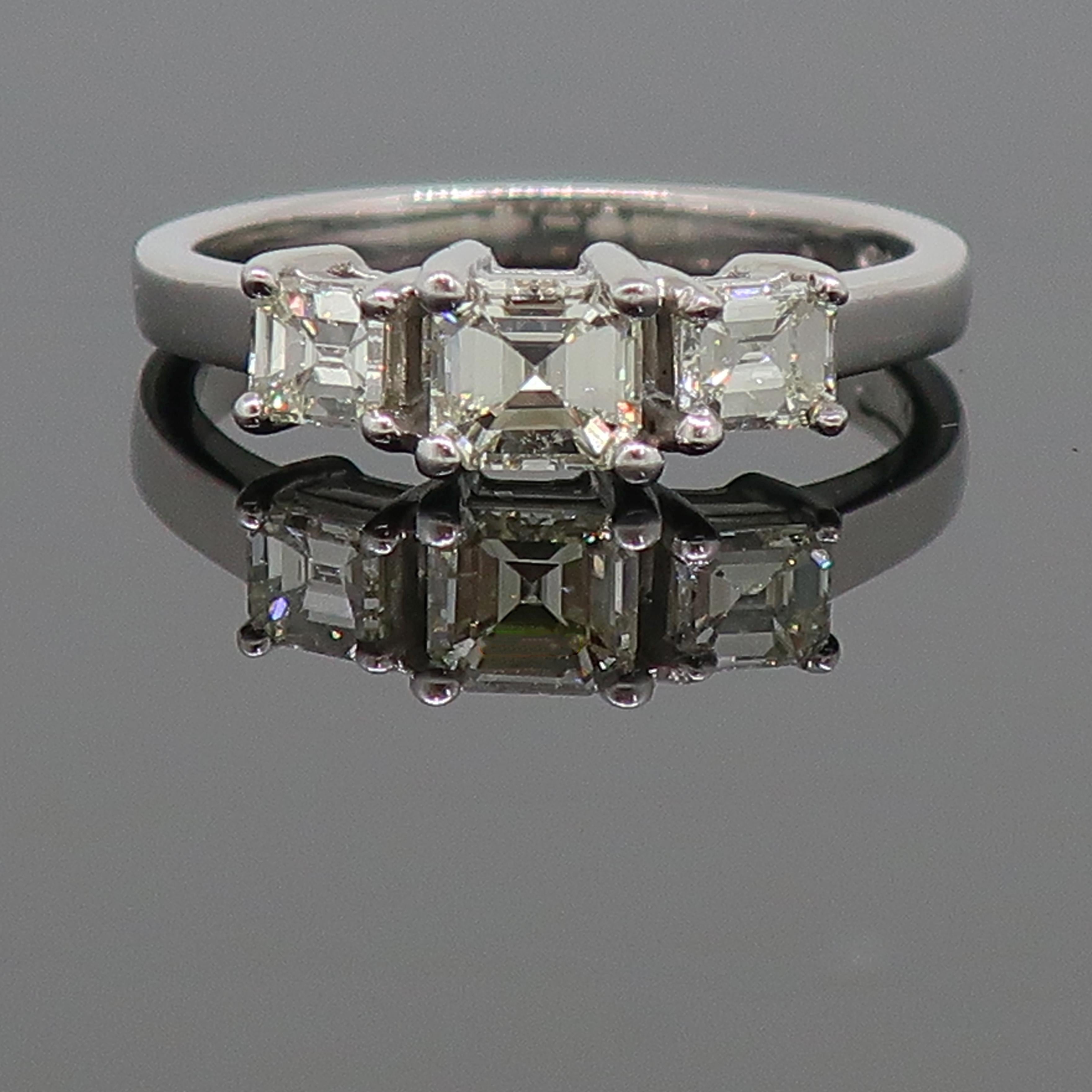 Emerald Cut Diamond Three-Stone Ring 18ct White Gold 0.76ct

A dazzling diamond three stone ring. Consisting of a larger almost square emerald cut stone in the centre, with a smaller almost square emerald cut diamond either side. The diamond in the