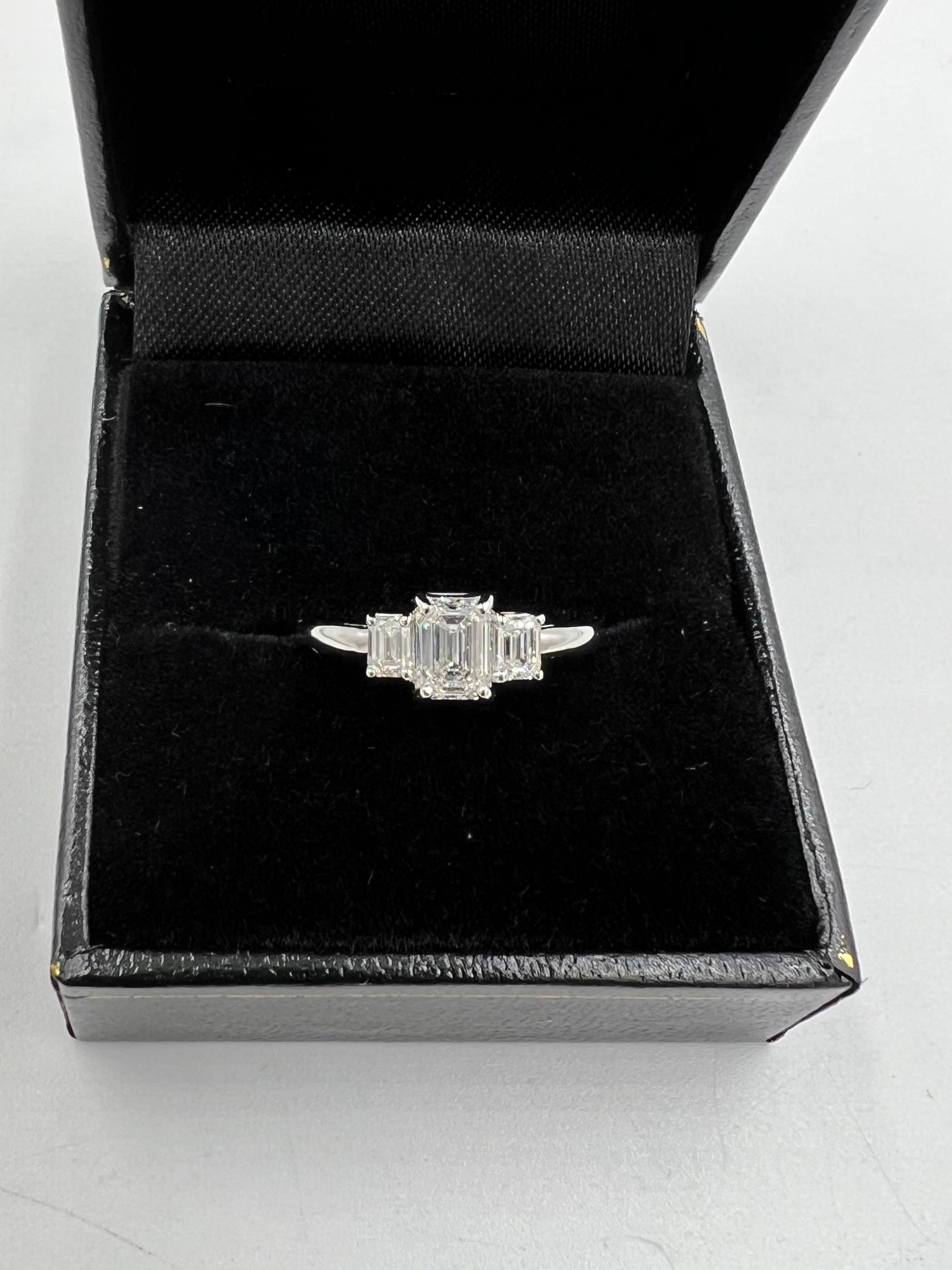 Emerald-cut diamond three-stone platinum ring, ca 1990s

The emerald-cut diamond three-stone platinum ring is a timeless symbol of elegance and sophistication. Crafted with precision and care, this exquisite piece of jewelry showcases the beauty and