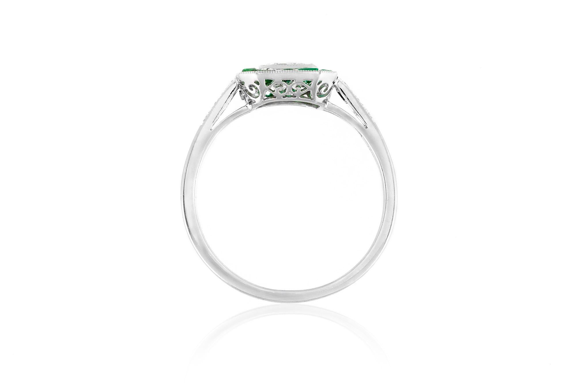 The ring is finely crafted in platinum with diamond as center stone weighing approximately total of 0.70 carat and emerald around weighing approximately total of 1.00 carat and round diamonds weighing approximately total of 0.70 carat.
