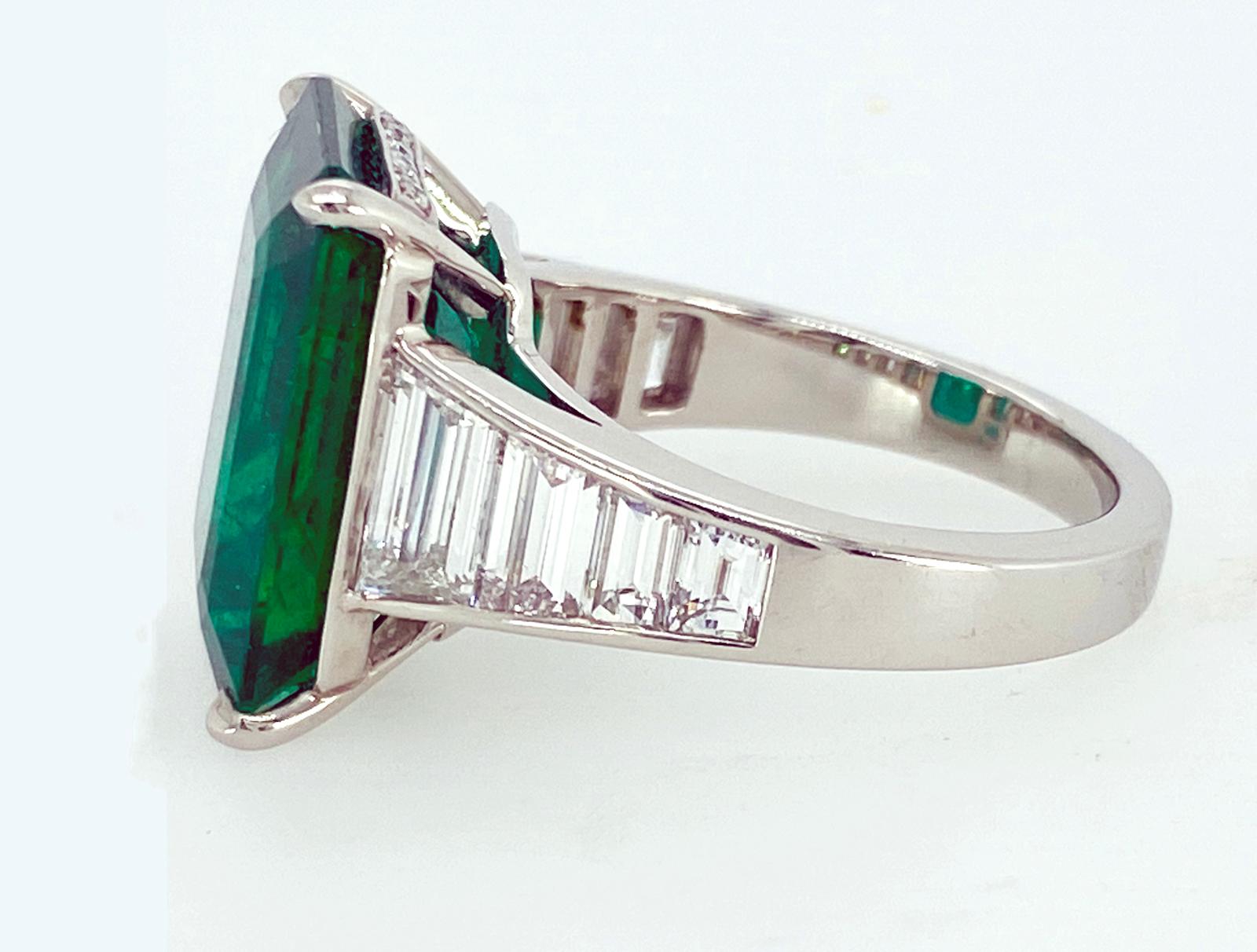 A single, emerald cut Emerald accented with six graduated emerald cut Diamonds is set in a hand fabricated,  Platinum setting.
Certified

Emerald:  8.88 carats
Eight Emerald cut Diamonds (5mm down to 3mm in length) and Diamond pave, 1.94 carats