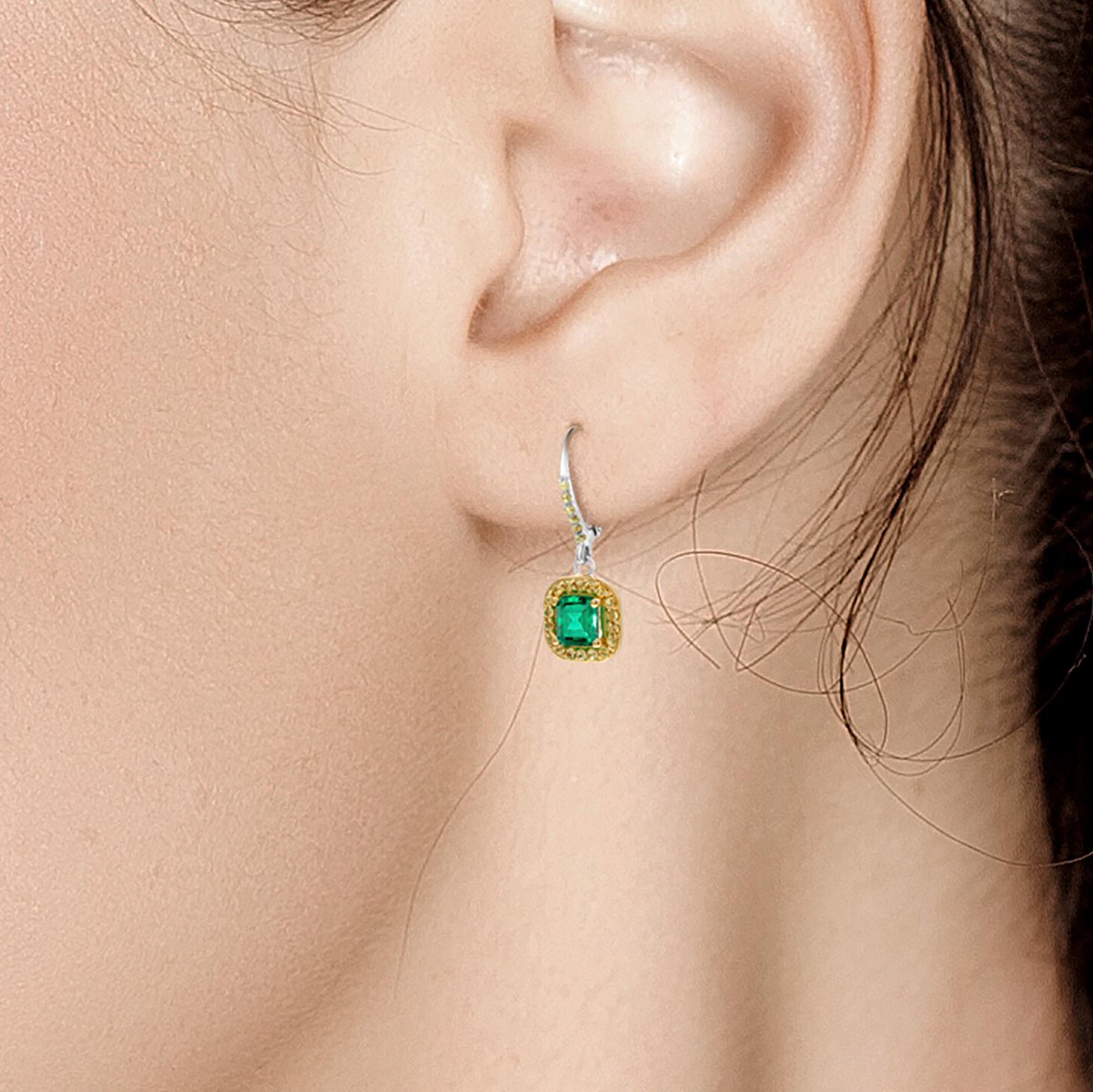 Fourteen karat white gold hoop earrings 
Emerald, with yellow sapphire accents
Emerald cut emerald weighing 1.85 carat 
Yellow Sapphire weighing 0.40 carat 
Earrings measuring 1.5-