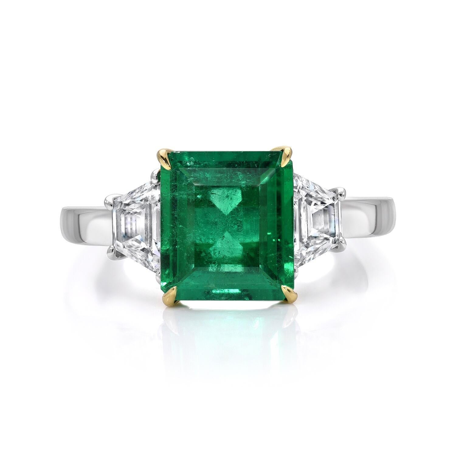 Colombian Emerald engagement ring featuring an emerald cut weighing a total of 1.85 carat flanked by a pair of Trapezoid diamonds weighing a total of 0.60 carats in Platinum.
The AGL certificate is attached to the images for your convenience. 
Ring