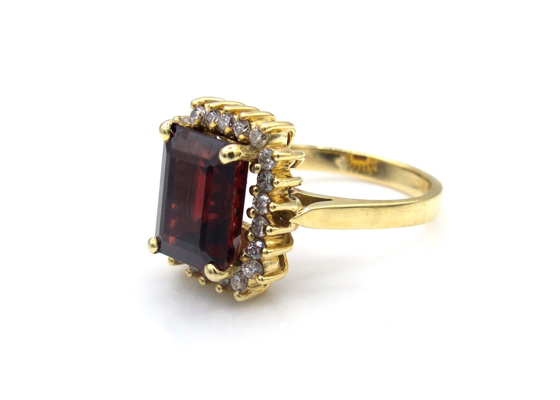 This stunning 4.5 Carat step-cut garnet is surrounded by 22 round-cut diamonds and set in 14K yellow gold.

Size 6

5.6 g