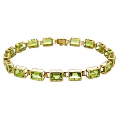 Emerald Cut Green Peridot Tennis Bracelet in 14k Yellow Gold