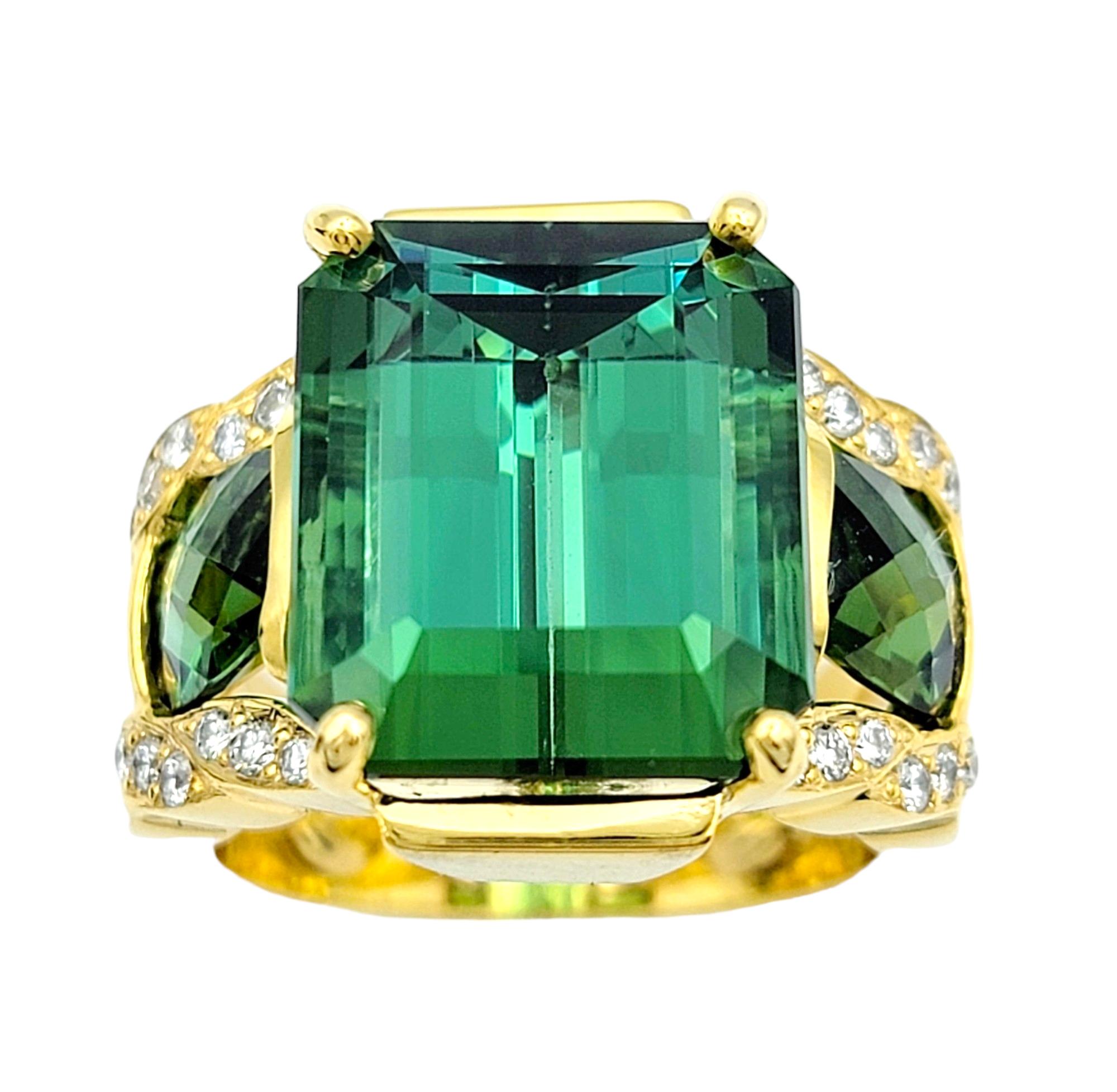 Ring size: 7

Elevate your jewelry collection with this exquisite three-stone green tourmaline ring. At its heart lies a captivating 13.25 carat emerald step cut tourmaline, exuding elegance and sophistication. Flanked by two checkerboard cut
