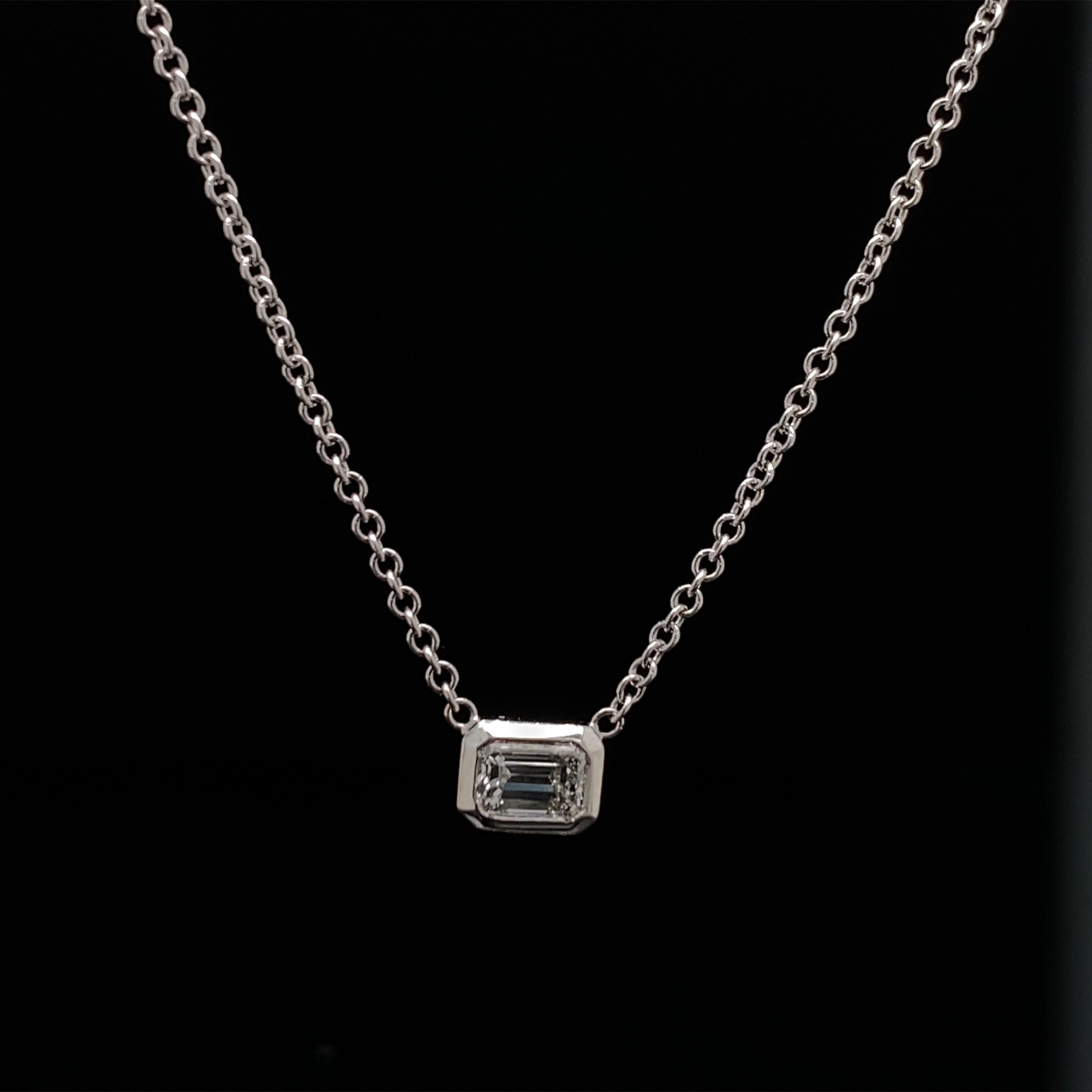 This Pendant features one  Emerald cut diamond that is set horizontally.
The Emerald cut diamond has a total carat weight of 0.17.
The diamond is F color, VS clarity.
The pendant is 16