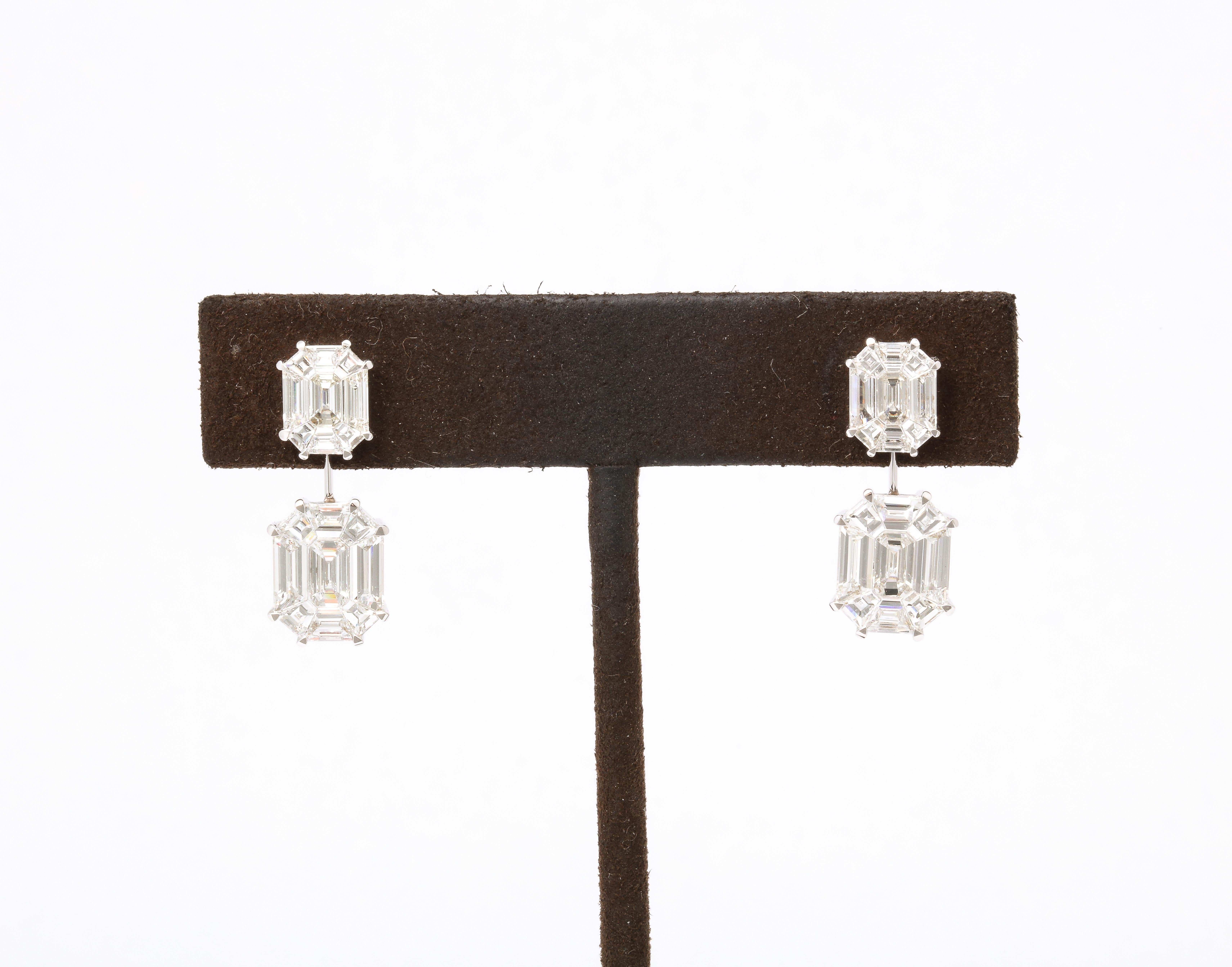 These earrings give the illusion of 5-6 carat EACH emerald cut drops! 

5.02 carats of F VS special cut diamonds, masterly set to look like one emerald cut diamond.

Set in 18k white gold

.90 inch length. 

A wearable pair of earrings, full of