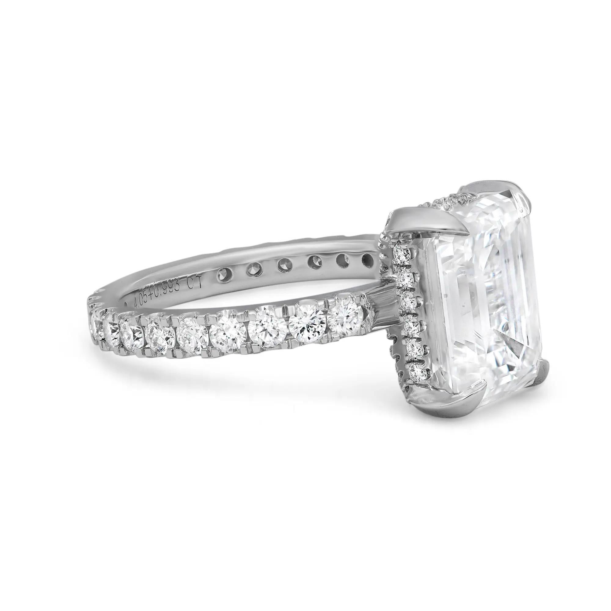 This enchanting ring is adorned with a sparkling GIA certified emerald cut lab grown diamond in the center, secured firmly in a beautiful four prong setting and a classic diamond shank that lends the final touch to the design aesthetic. The total