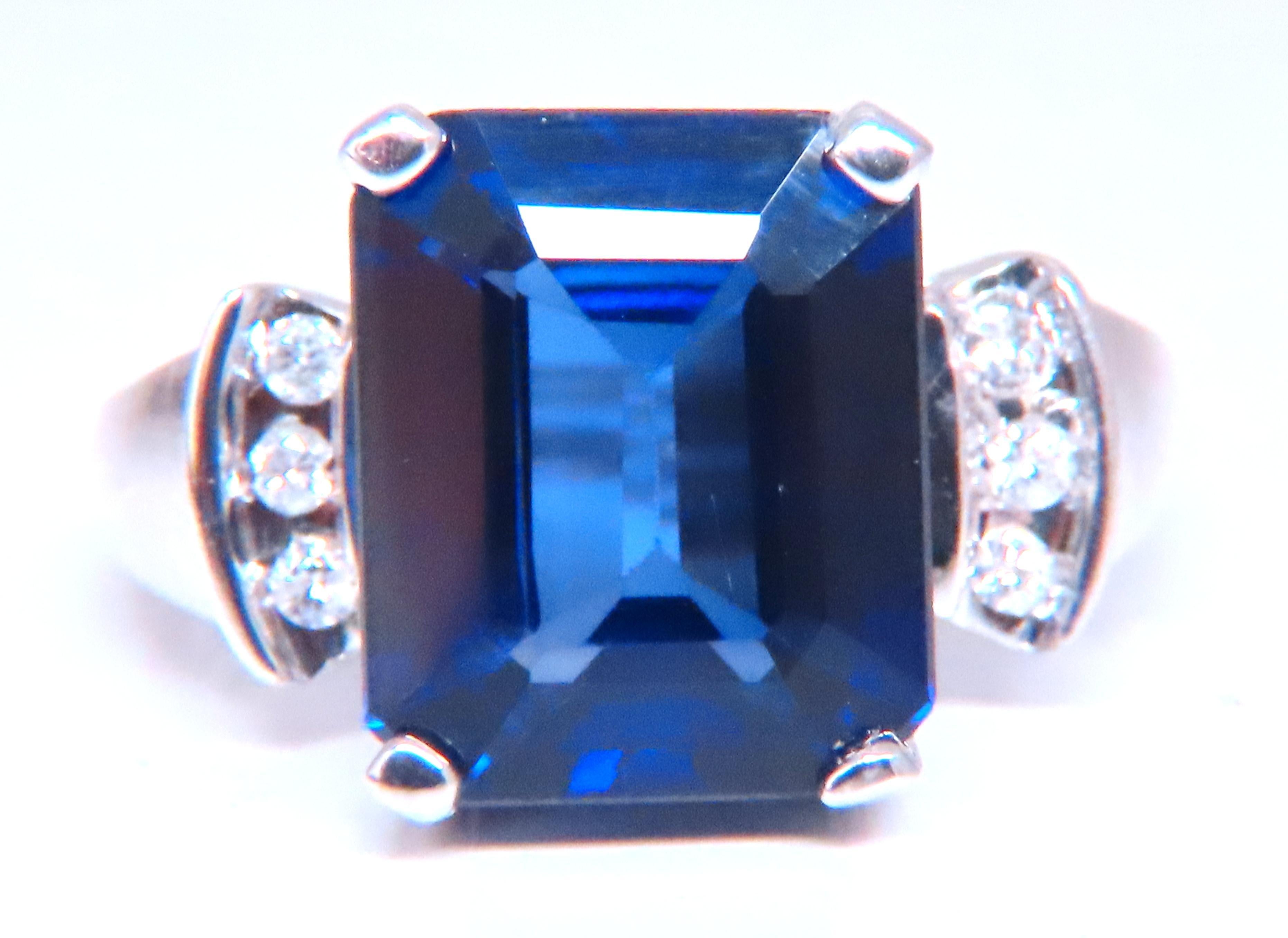 Lab Created  Sapphire Ring
Classic Royal Blue
Emerald Cut, Clean Clarity
11 x 9mm
.12ct Diamonds
H-color Vs-2 clarity
14kt white gold
5.5 grams
Depth 8mm 
Size 6.25