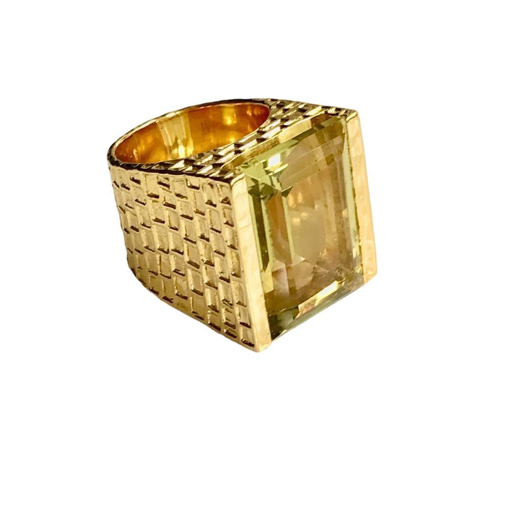 The large Emerald Cut Lemon Quartz set within a deeply chiselled 'architectural' mount; this is a fabulously striking ring entering on a beautifully cut, bright & well proportioned stone. 

The stone measures 22mm x 15mm; the ring stands 11mm
