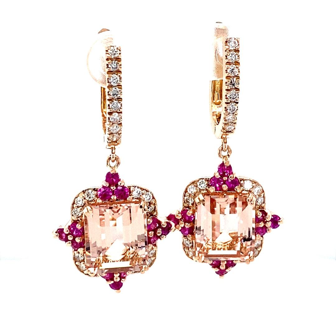 These earrings have Emerald Cut Morganites that weigh 8.65 carats, Round Cut Pink Sapphires that weigh 1.08 carats, and Round Cut Diamonds that weigh 0.67 carats. The total carat weight of the earrings is 10.40 carats.

The earrings are crafted in