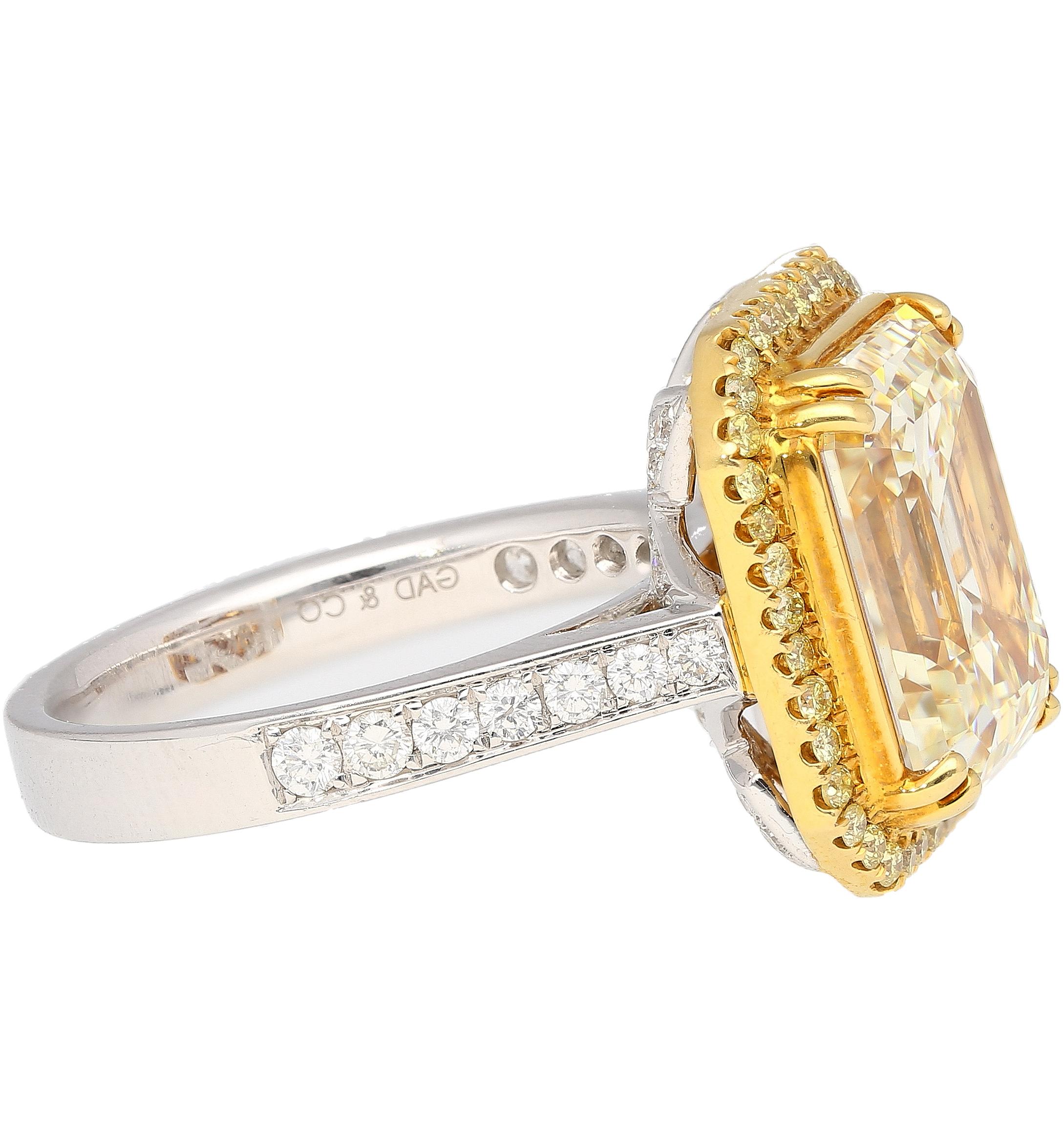 Art Deco Emerald Cut Natural 7.25 Carat Fancy Light Yellow Diamond & Diamond Halo Ring For Sale