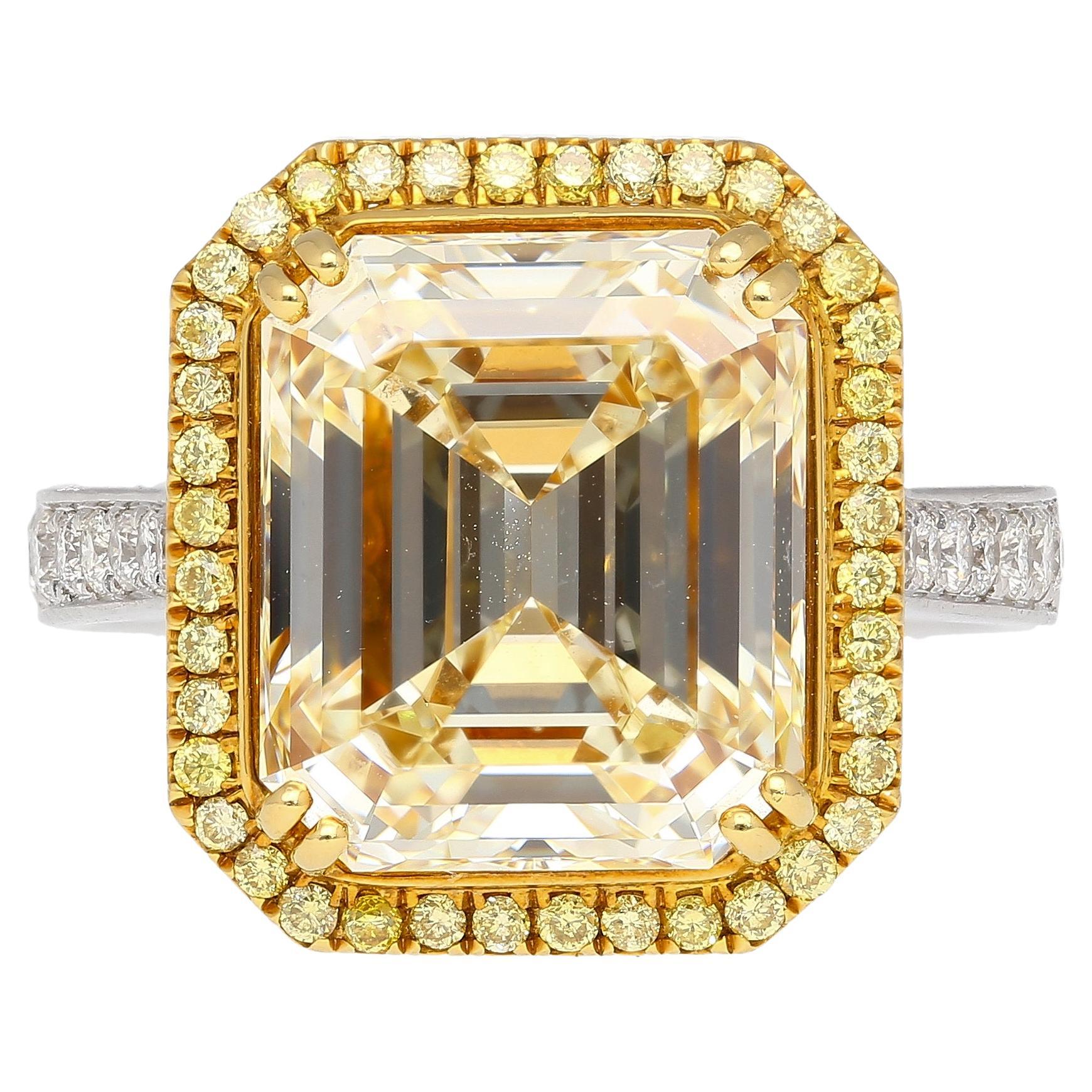 Emerald Cut Natural 7.25 Carat Fancy Light Yellow Diamond & Diamond Halo Ring For Sale