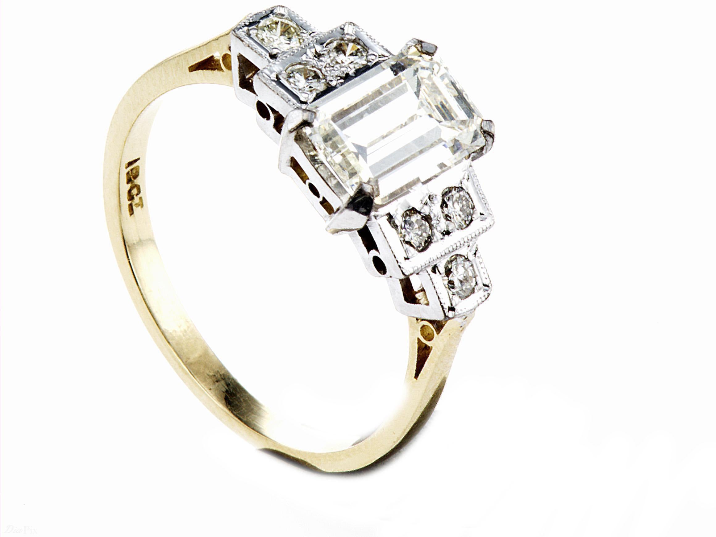 Emerald-Cut Natural Diamond Ring The central diamond measures 8.78mm x 5.64mm x 3.51mm Weighing 1.50ct. GradedI IJ VS1.
The supporting shoulder stone 3 to each side weigh .12ct also I/J VS. The diamonds mounted in a platinum setting to an 18ct