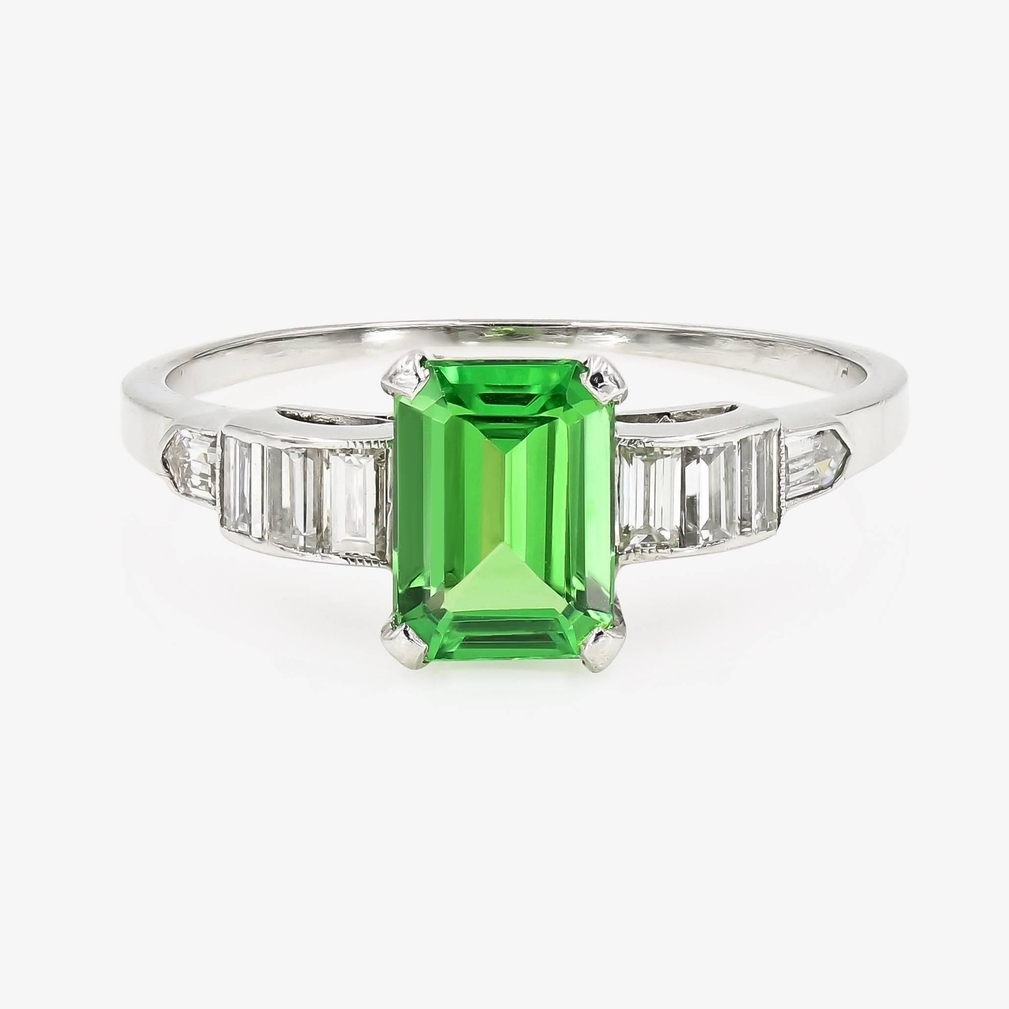 This rich green emerald cut natural Tsavorite is 1.22cts. with 8 baguette diamonds down the sides of the shank= .43ct. t.w. (G color and VVS-VS in clarity) The Tsavorite is from Kenya, and measures 7.6x5.4mm. The entire ring is made in